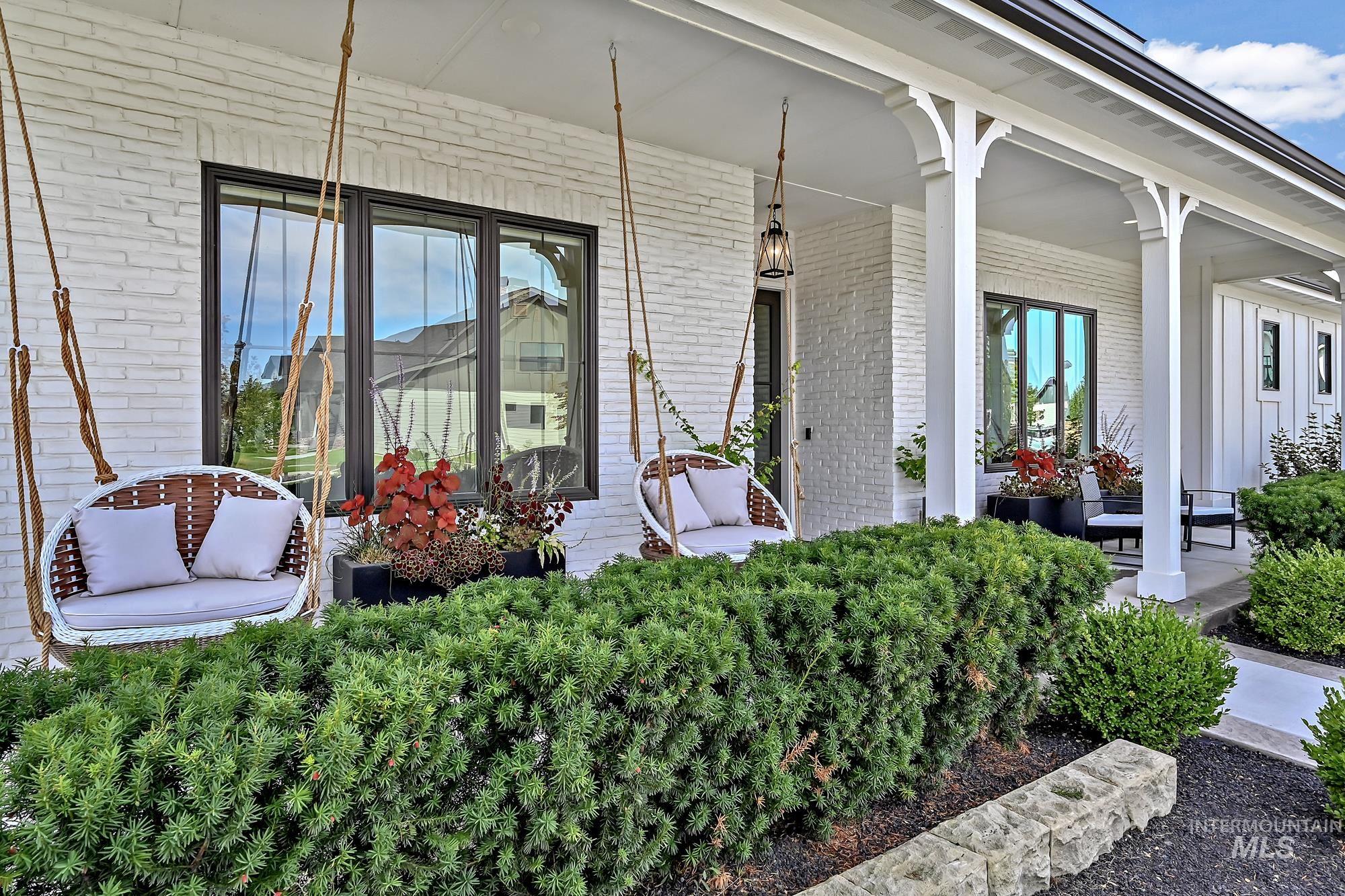 Doorway to property with a porch and brick siding