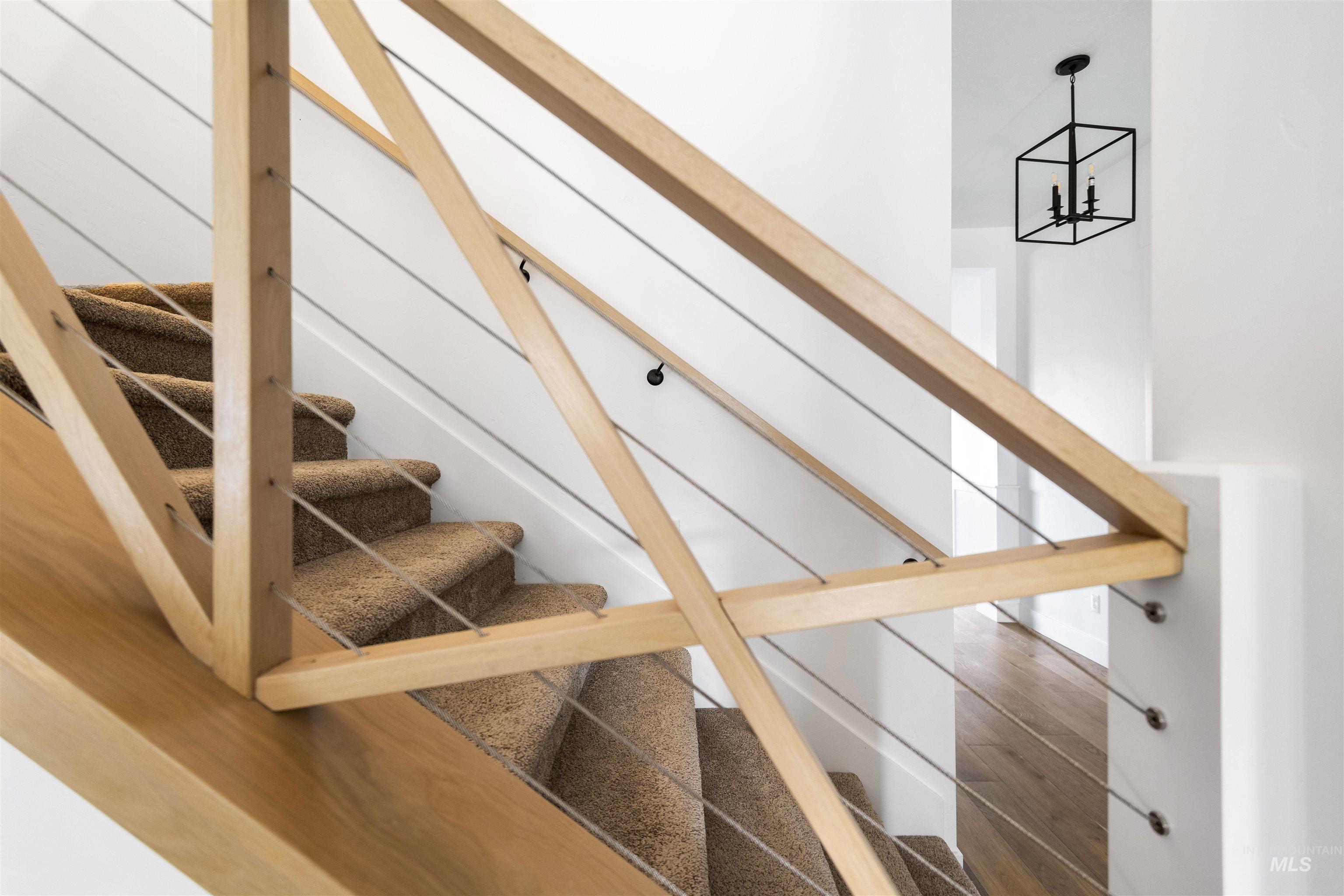 Stairs featuring wood finished floors