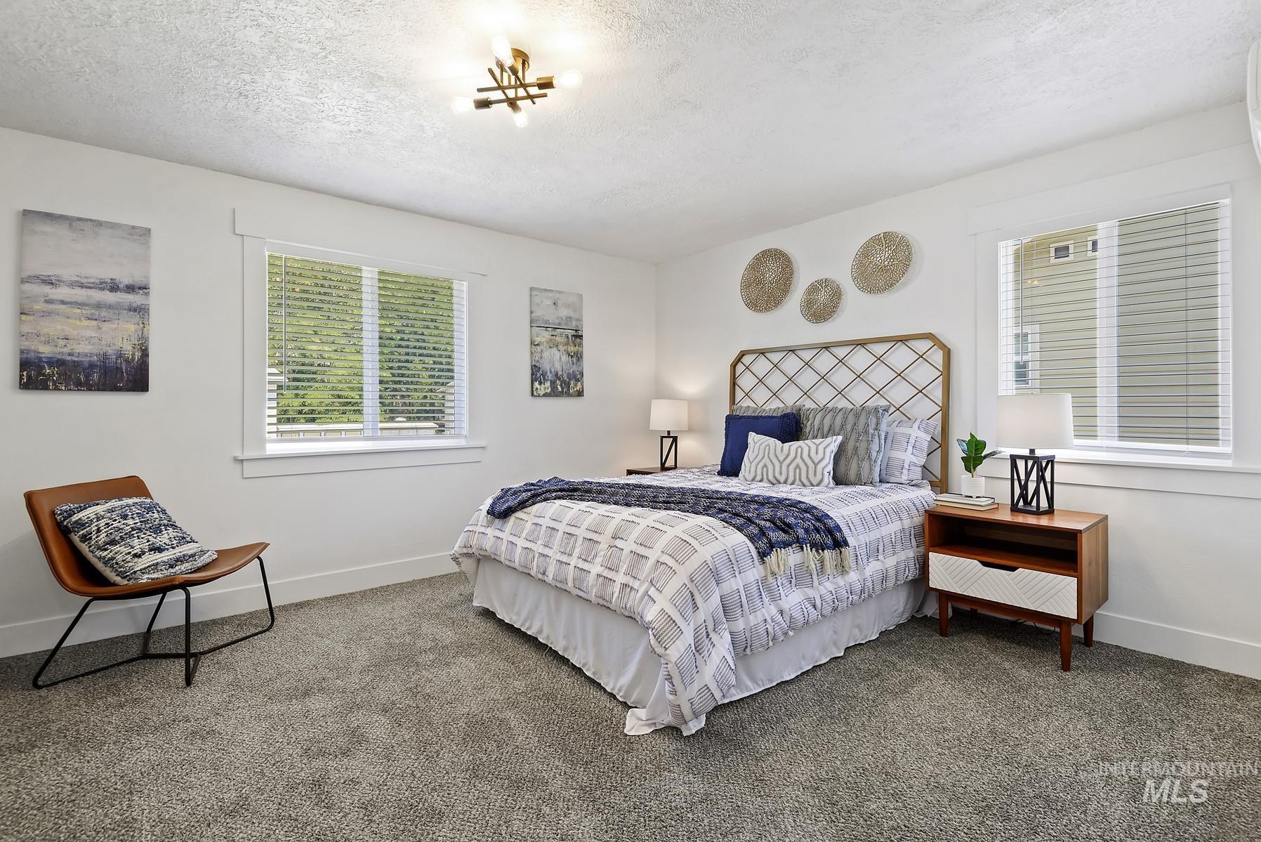 Bedroom with carpet floors and a textured ceiling