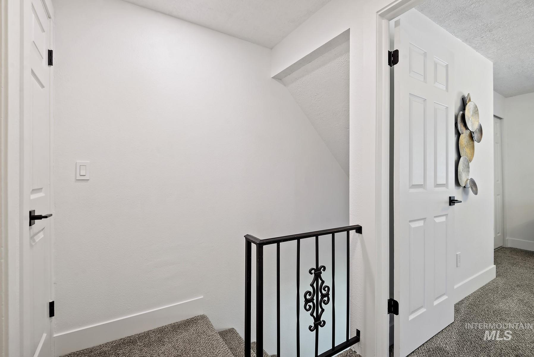 Stairway featuring carpet and baseboards