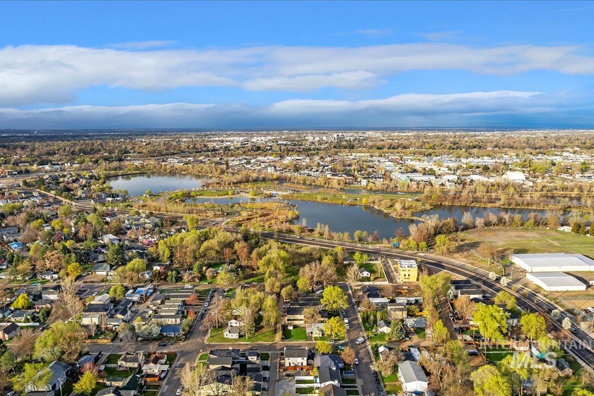 Aerial view of property's location with nearby suburban area and a large body of water