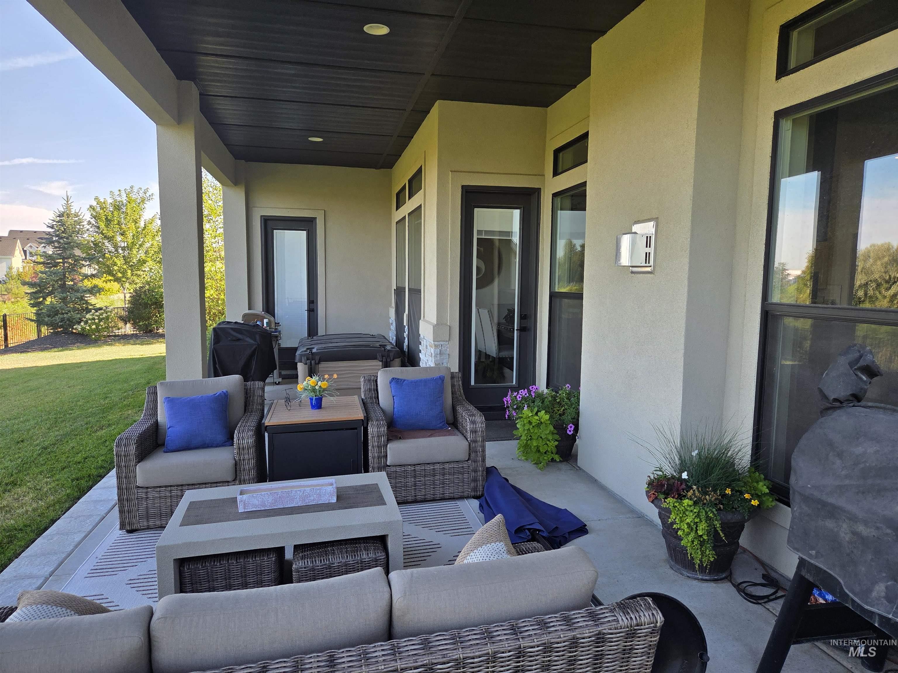 View of patio with outdoor lounge area and grilling area