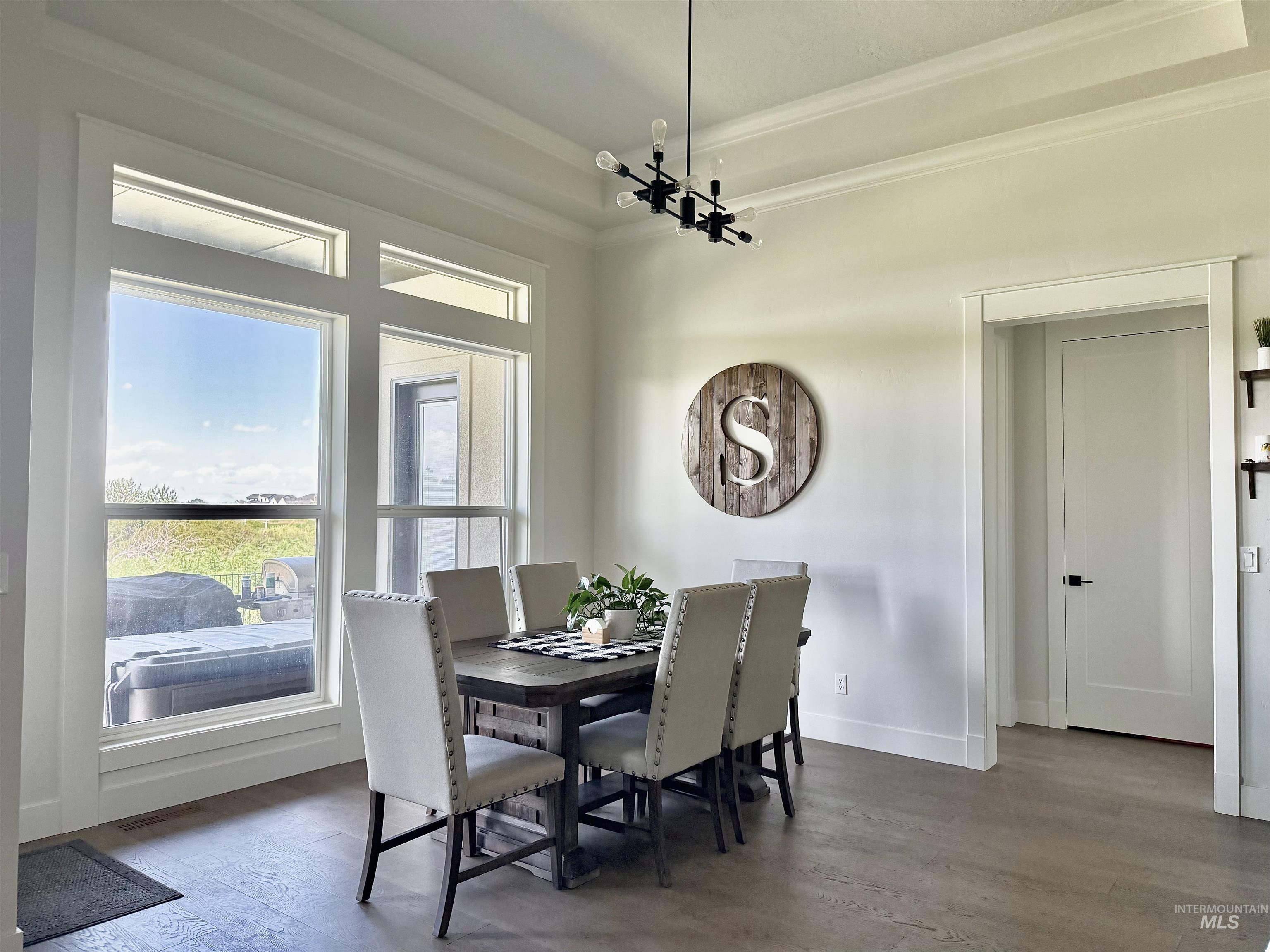 Dining area featuring wood finished floors and ornamental molding