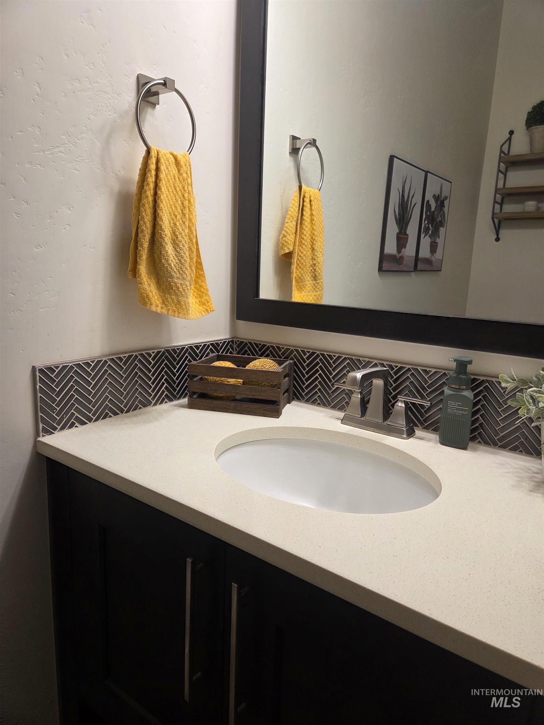 Bathroom with vanity and backsplash