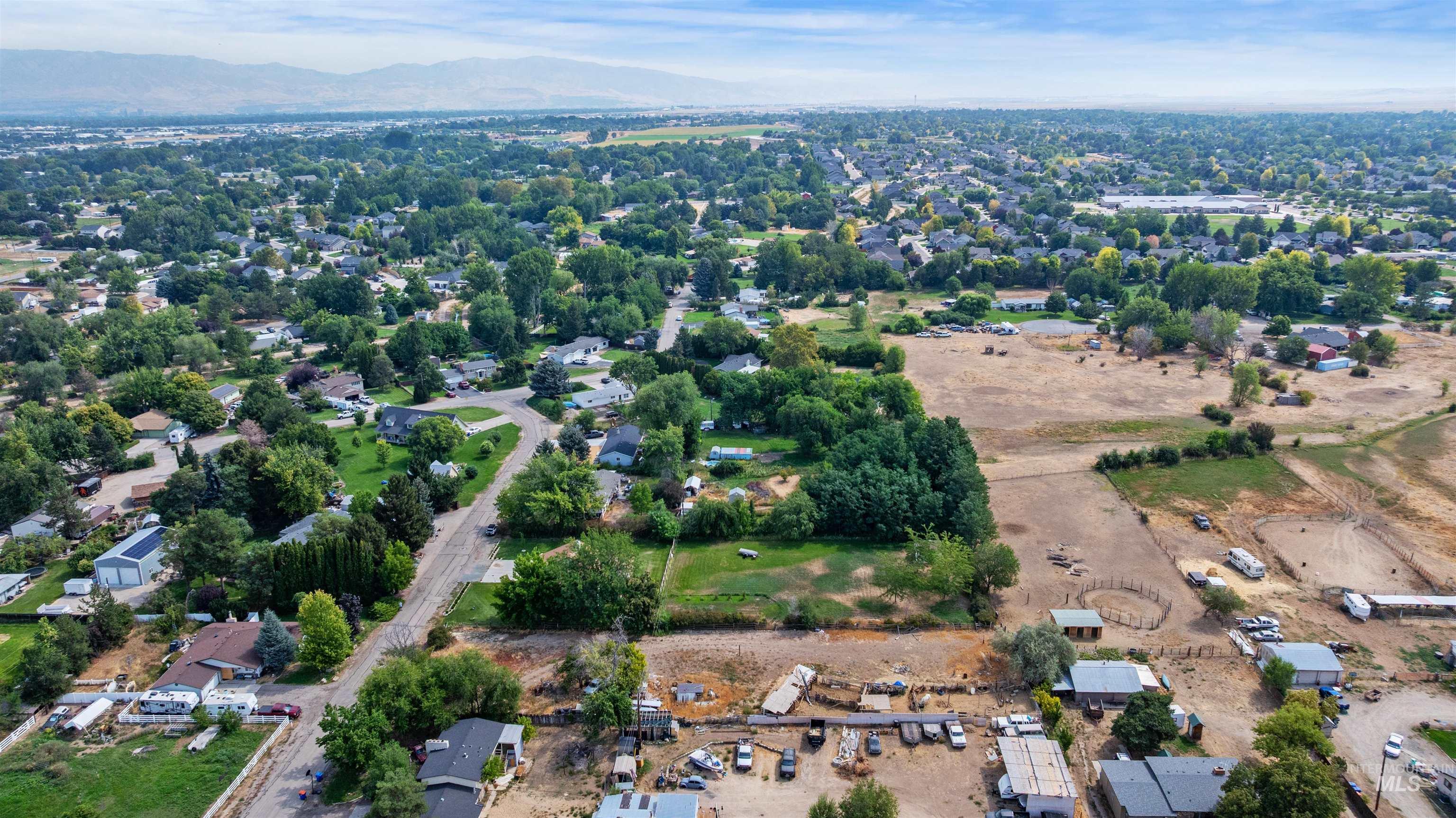 Aerial view of property's location with a mountainous background