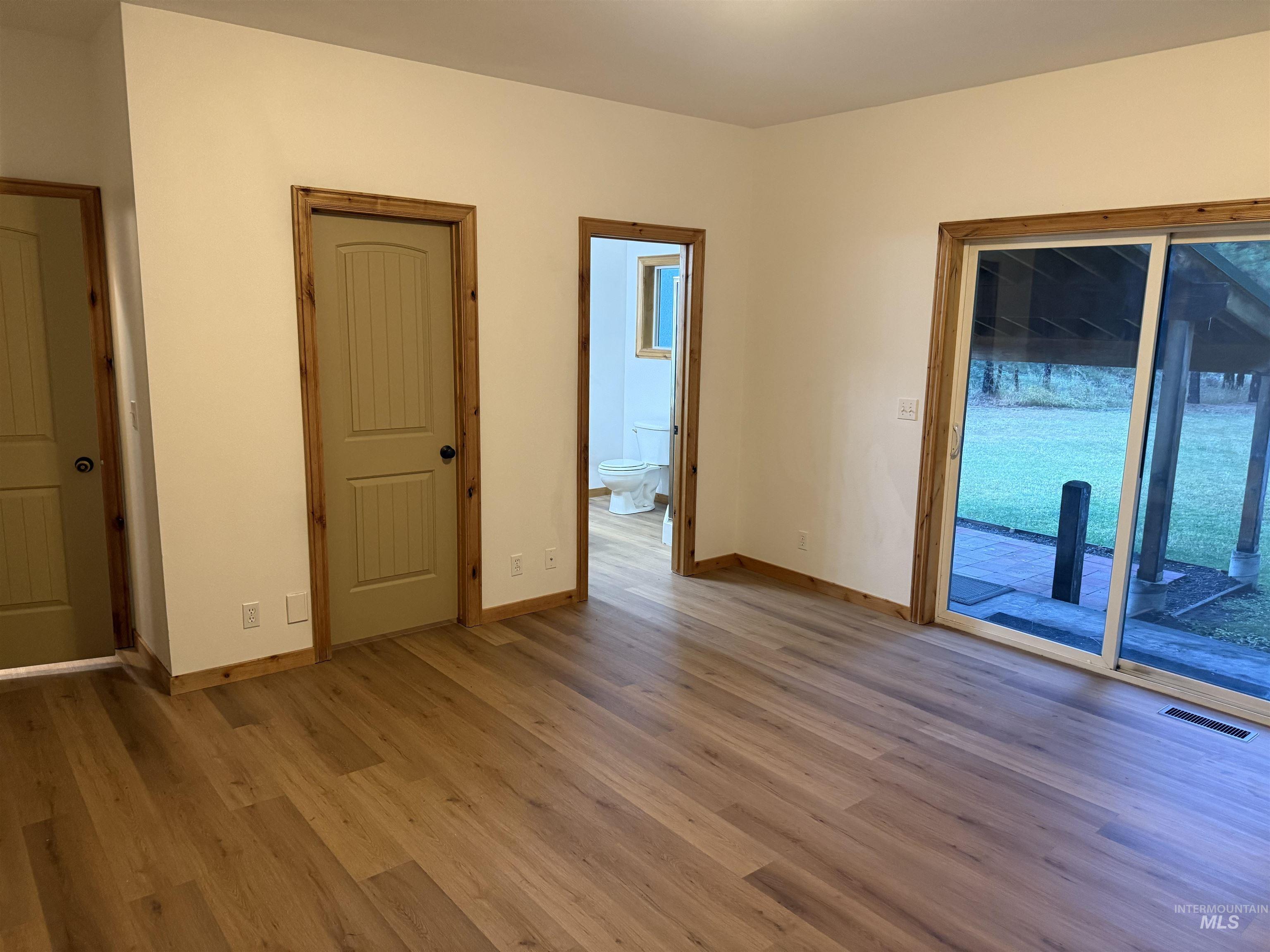 Spare room featuring wood finished floors and baseboards