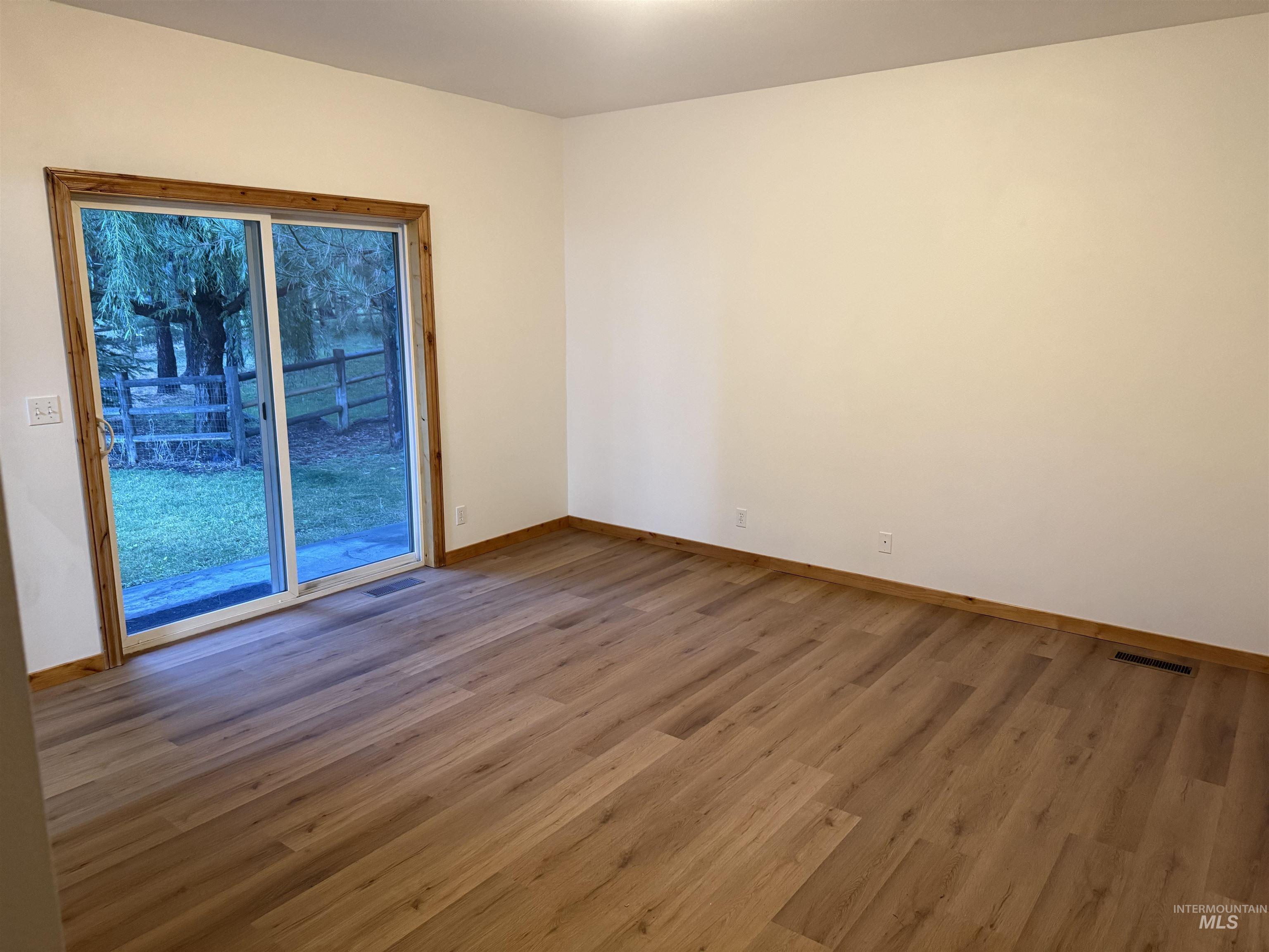 Unfurnished room featuring wood finished floors