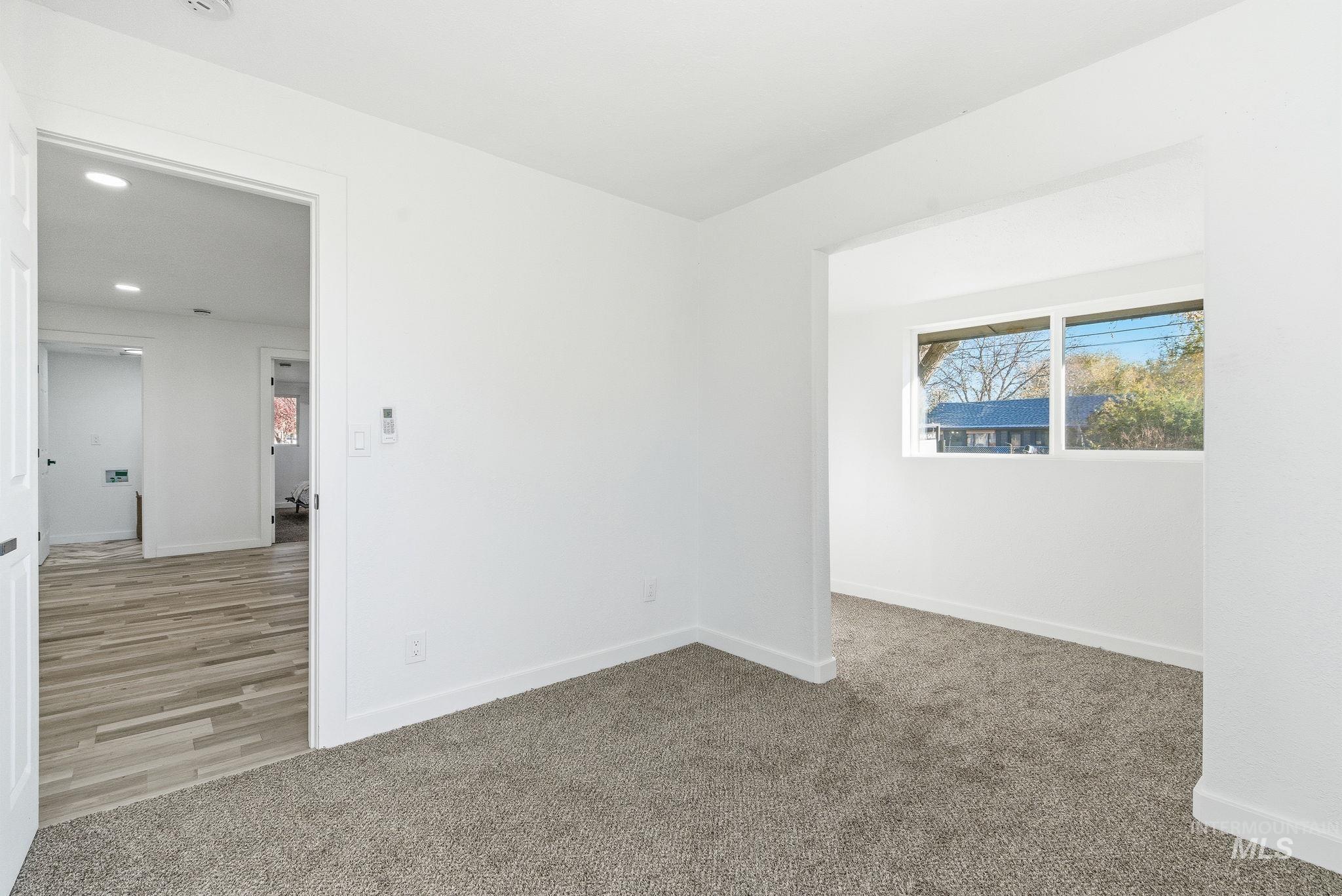 Empty room featuring light carpet and recessed lighting
