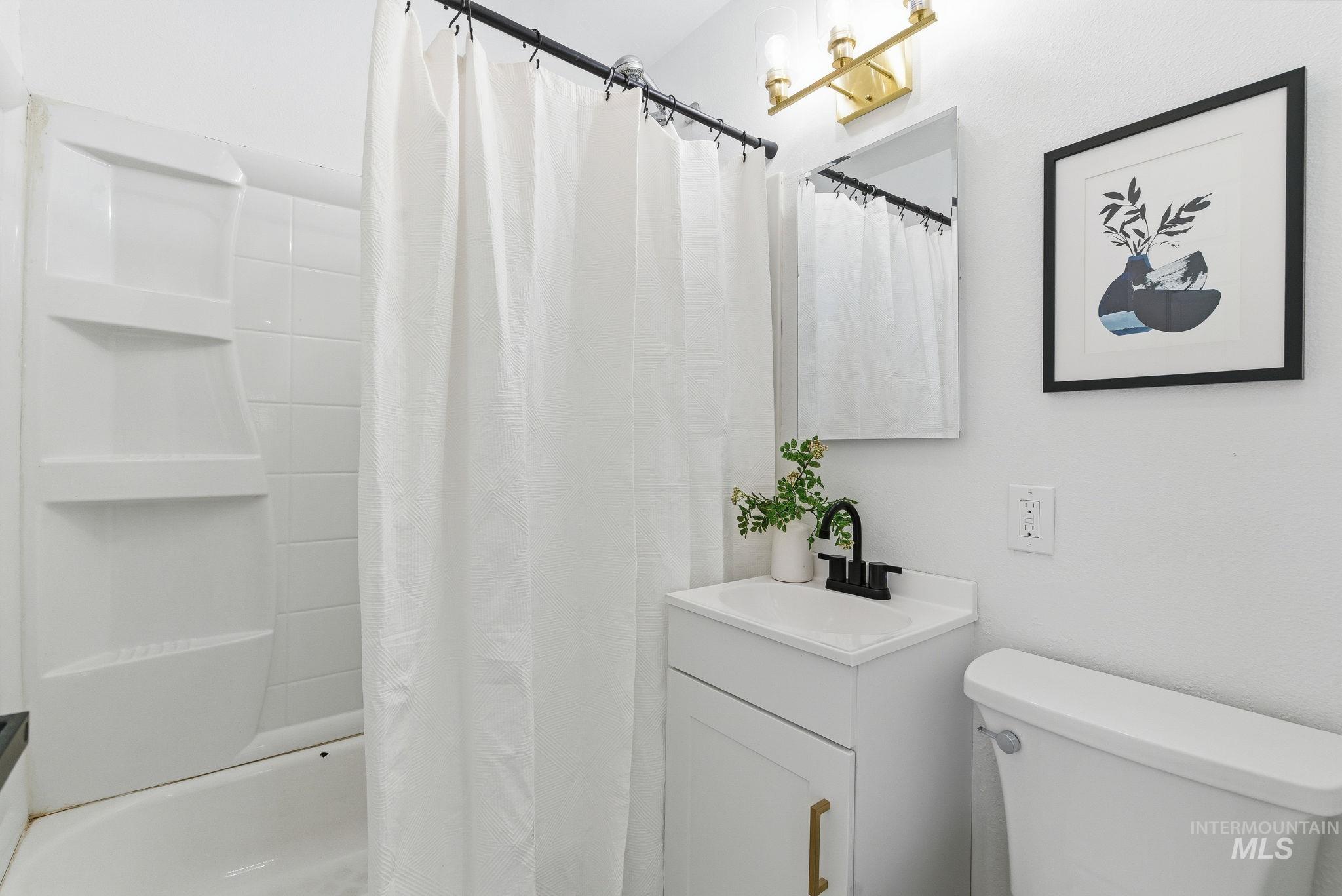 Full bathroom with vanity and shower / bath combo with shower curtain