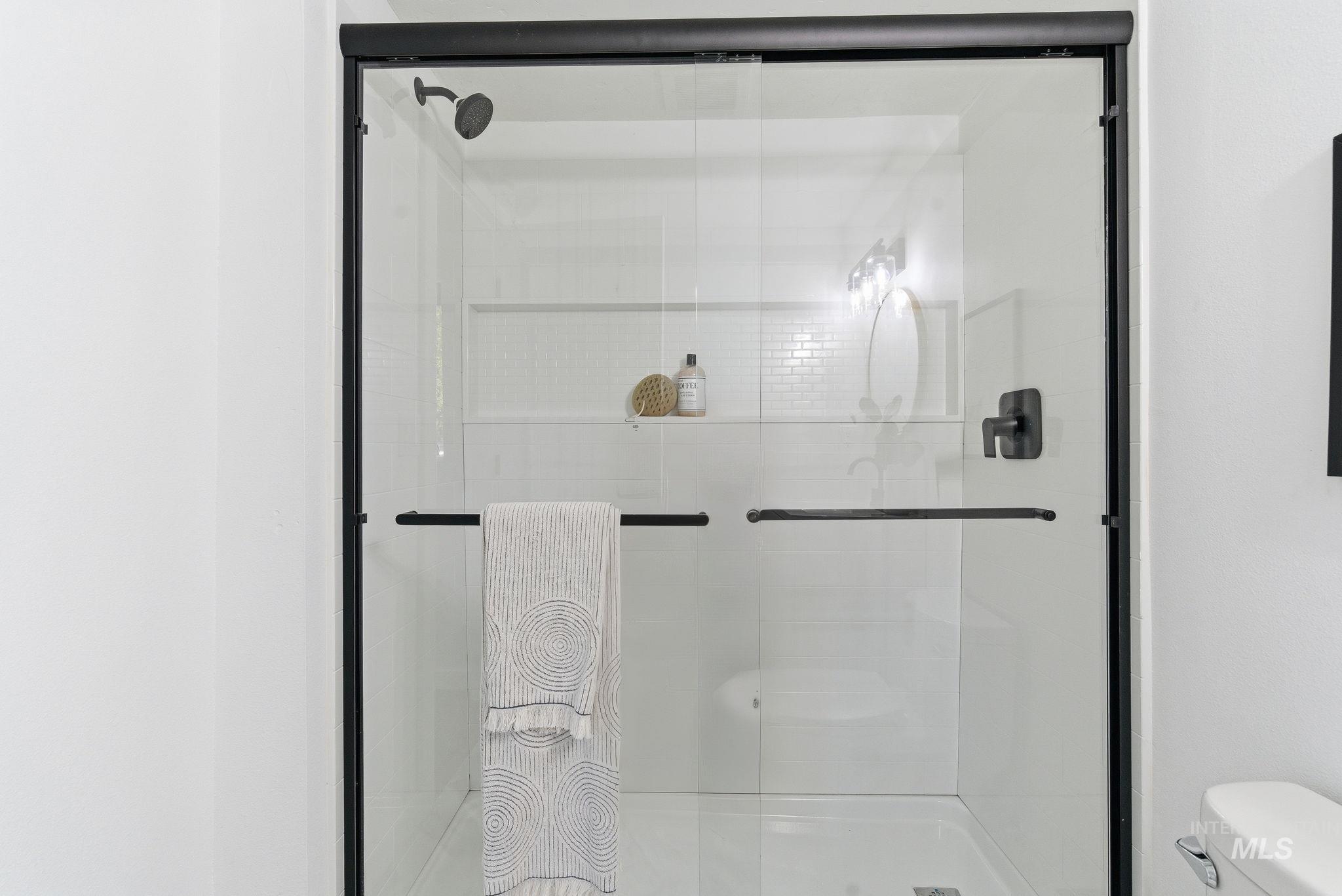 Bathroom featuring toilet and a shower stall