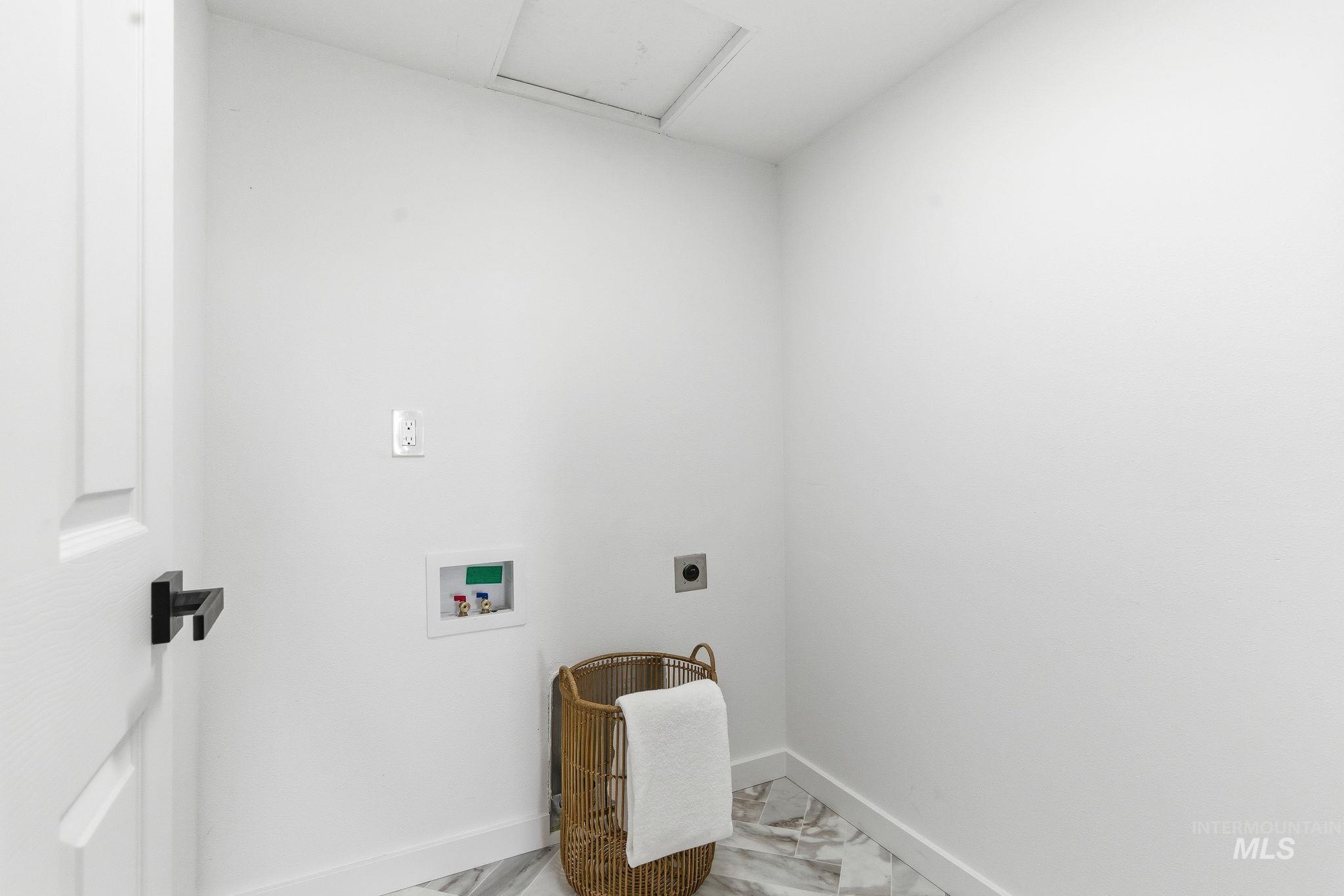 Laundry area featuring washer hookup, hookup for an electric dryer, and light marble finish floors