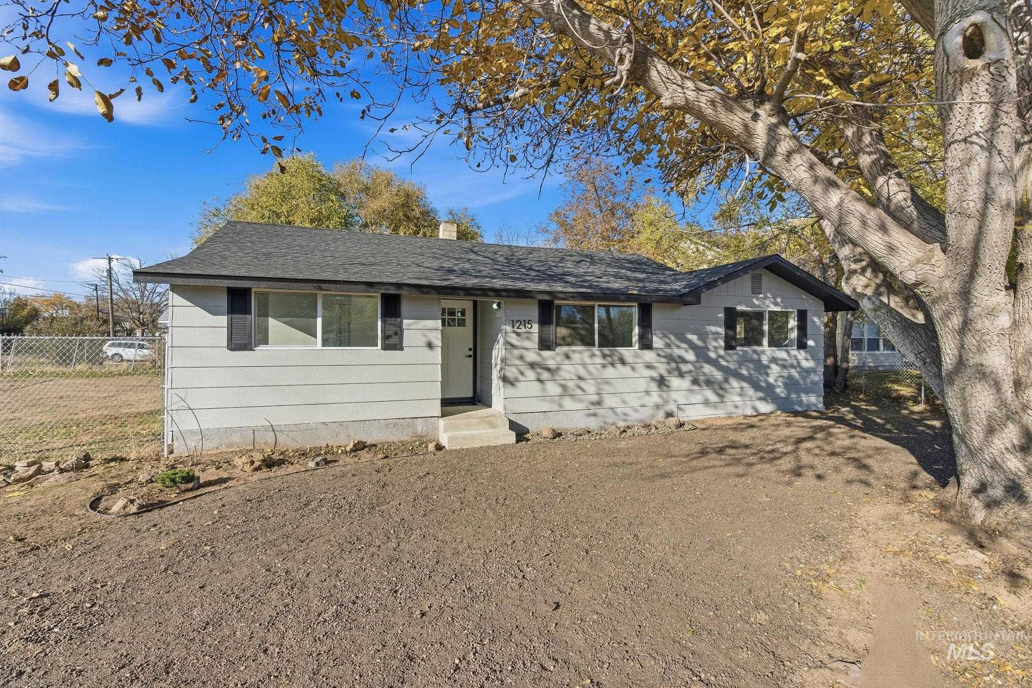 Ranch-style home with roof with shingles and a chimney