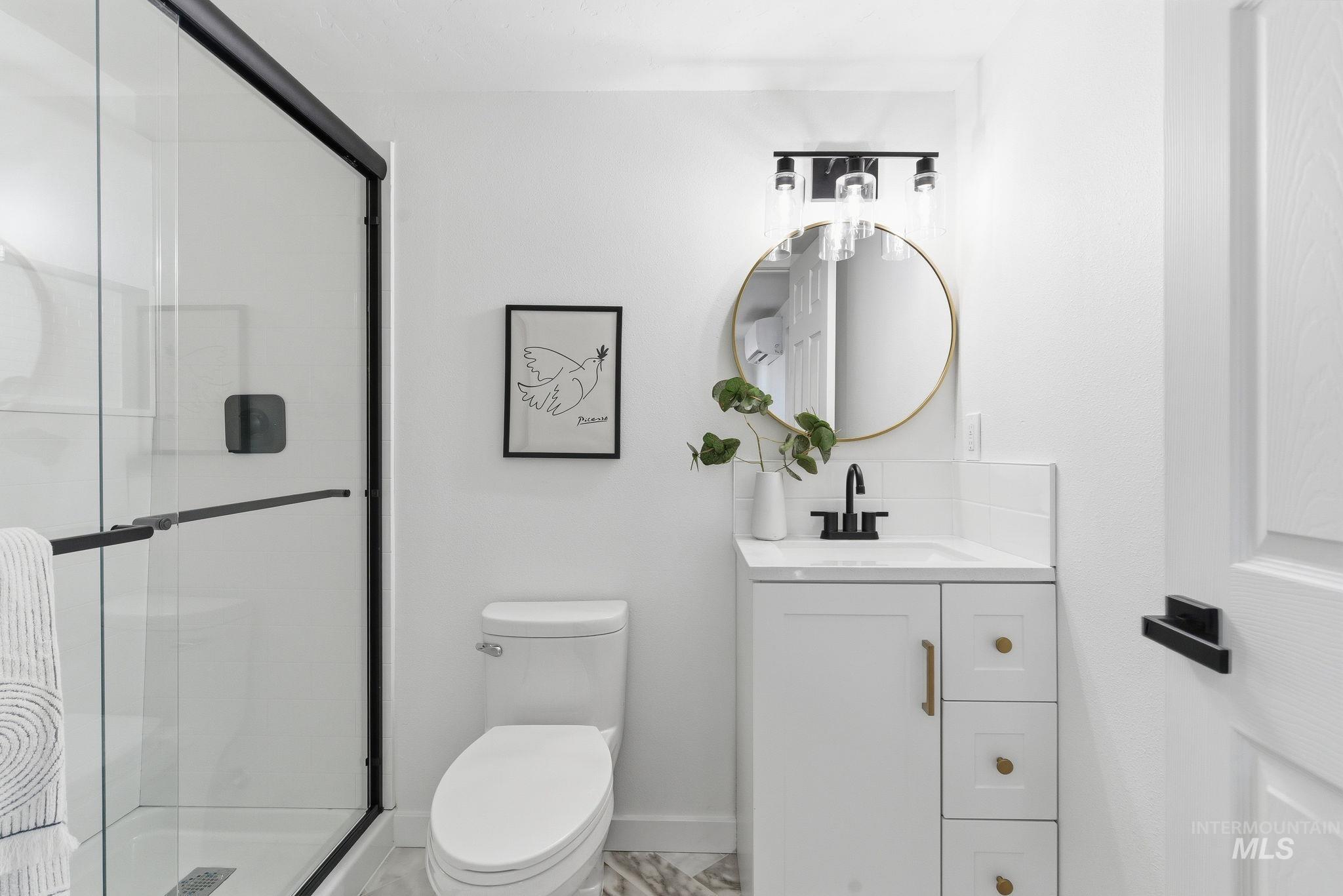 Bathroom with vanity and a shower stall