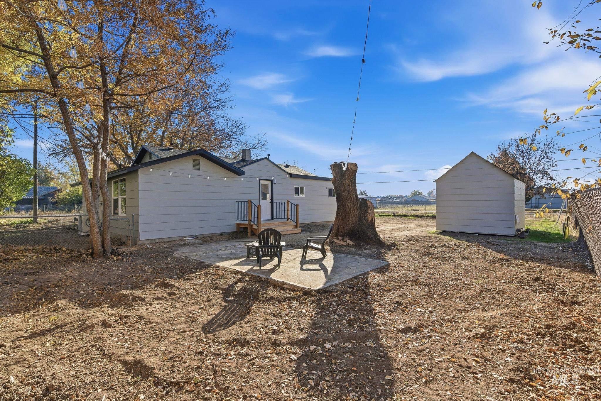 Back of property featuring a patio area and an outdoor structure