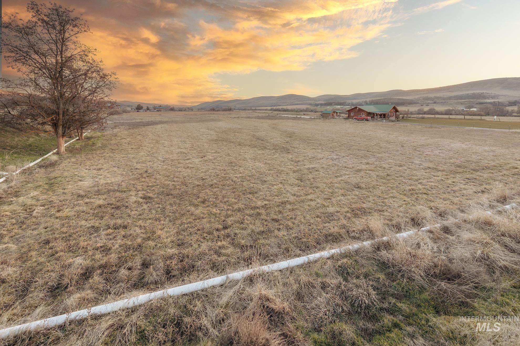 Yard at dusk featuring a view of countryside and a mountain view