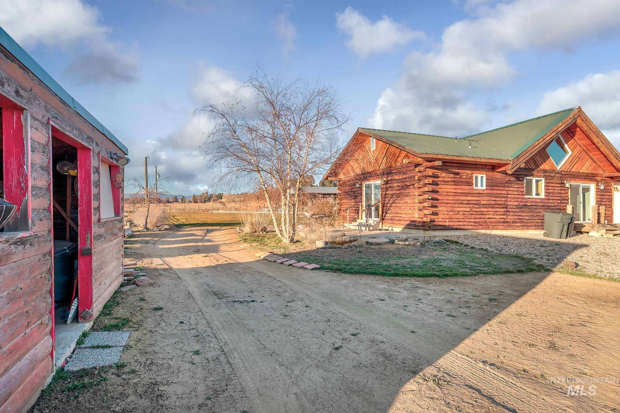 View of side of property featuring a metal roof and log exterior