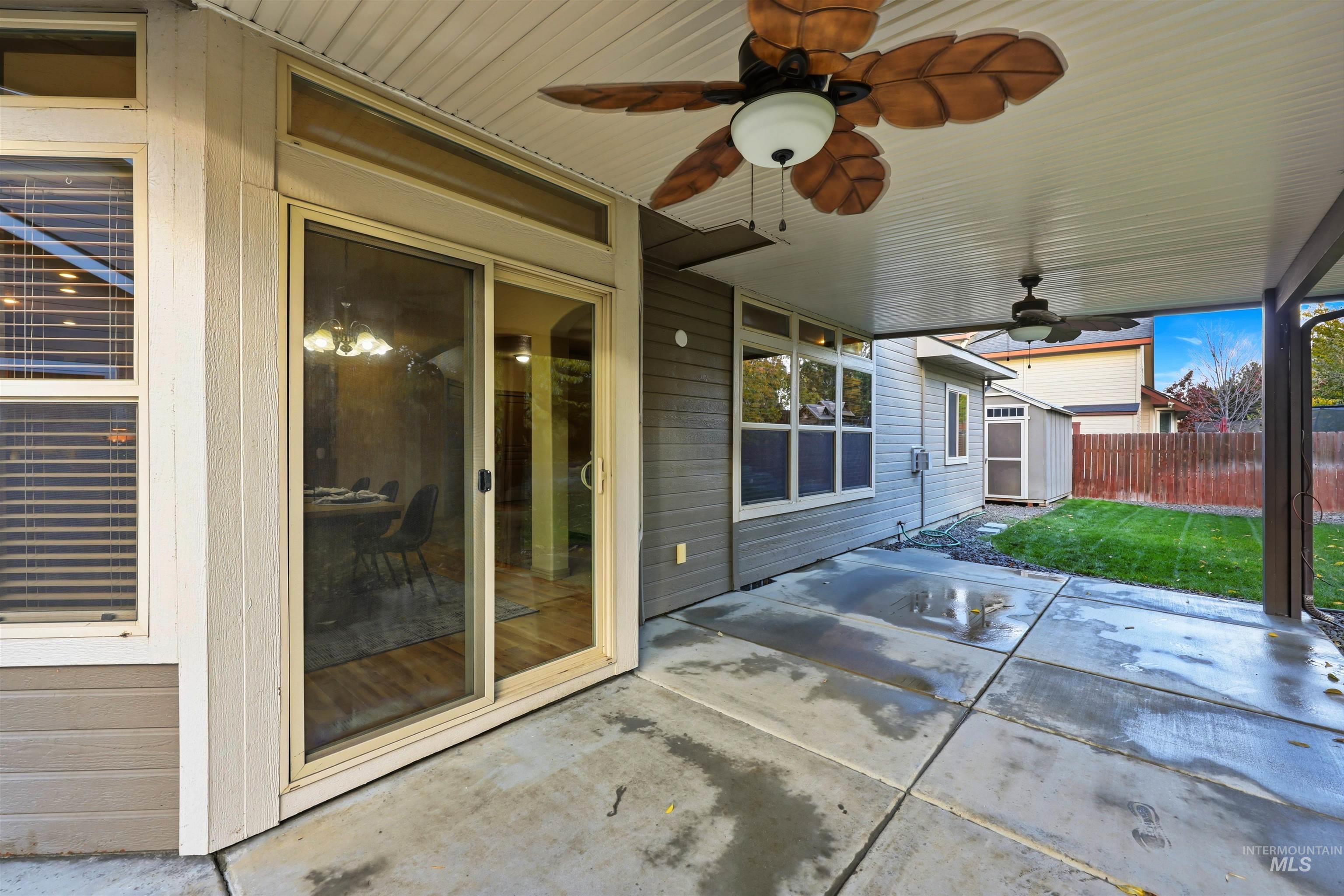 View of patio featuring a ceiling fan and a storage shed