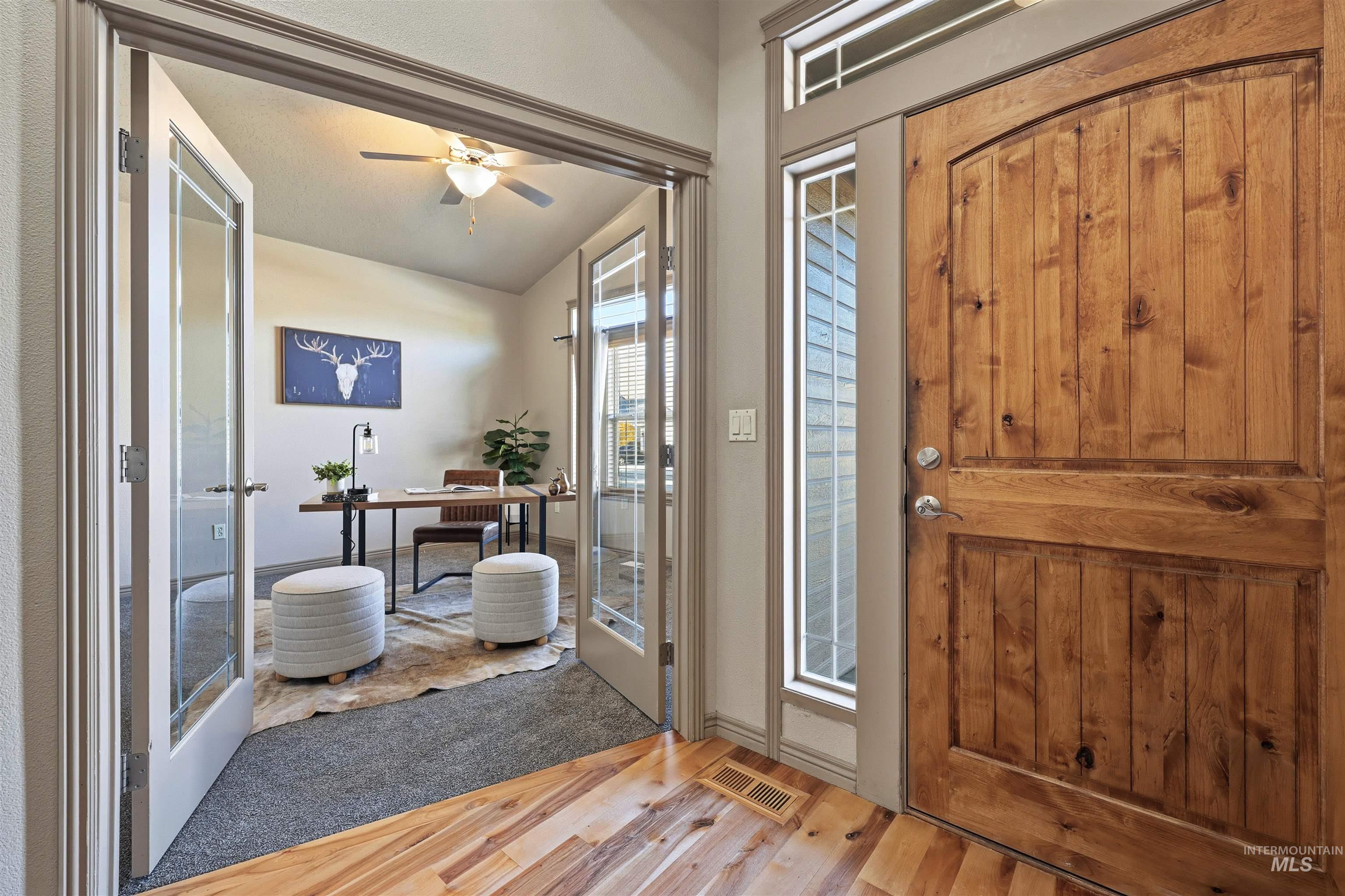 Entrance foyer featuring french doors, light wood-style floors, and ceiling fan