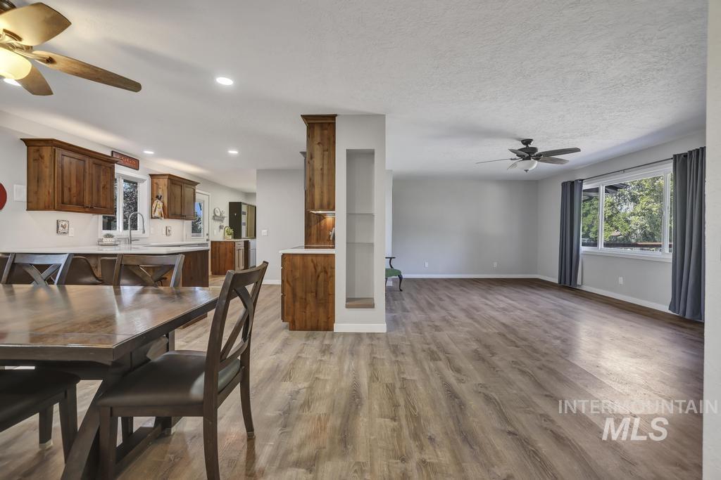 Dining room with a ceiling fan, light wood finished floors, and recessed lighting