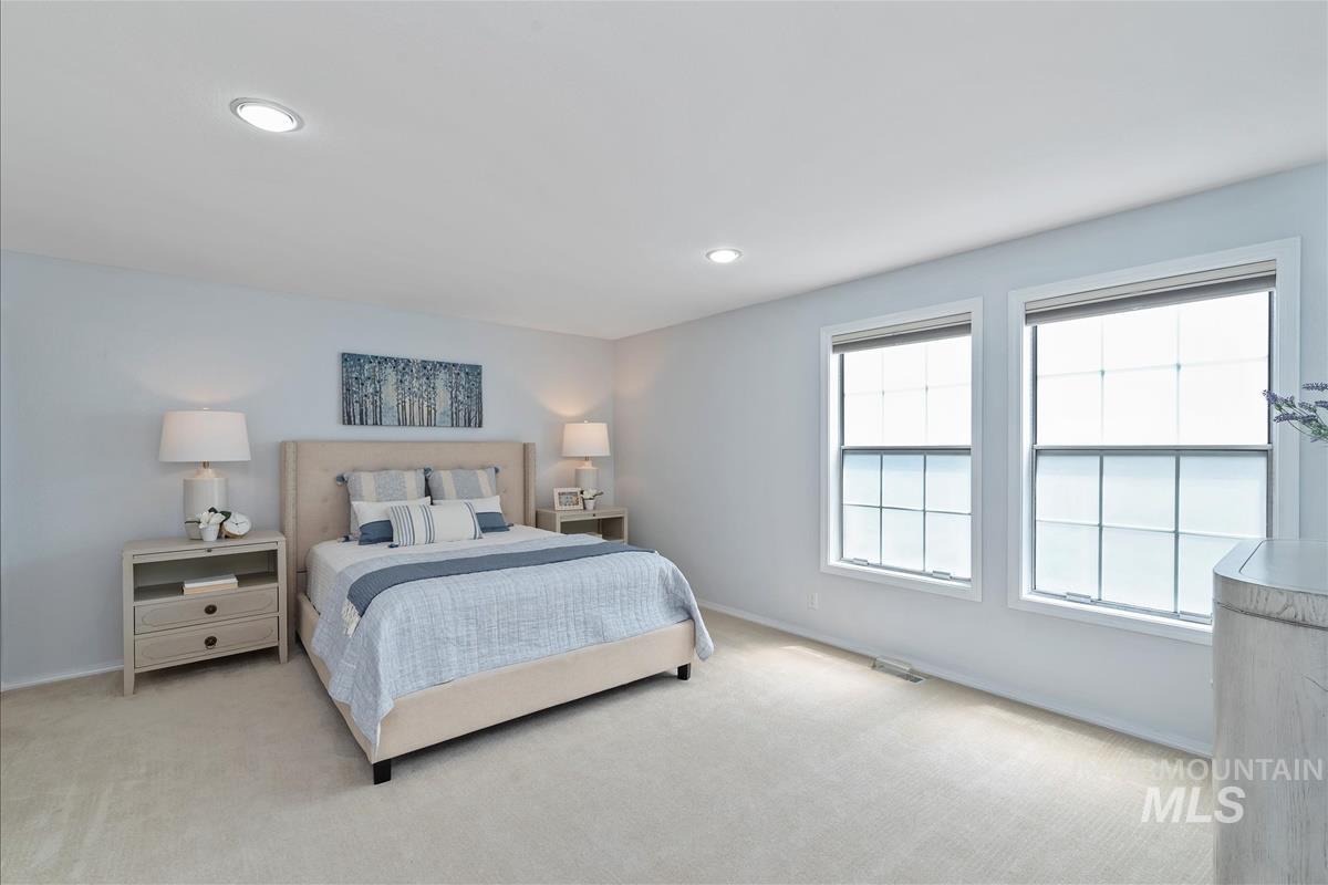 Bedroom featuring light carpet and recessed lighting