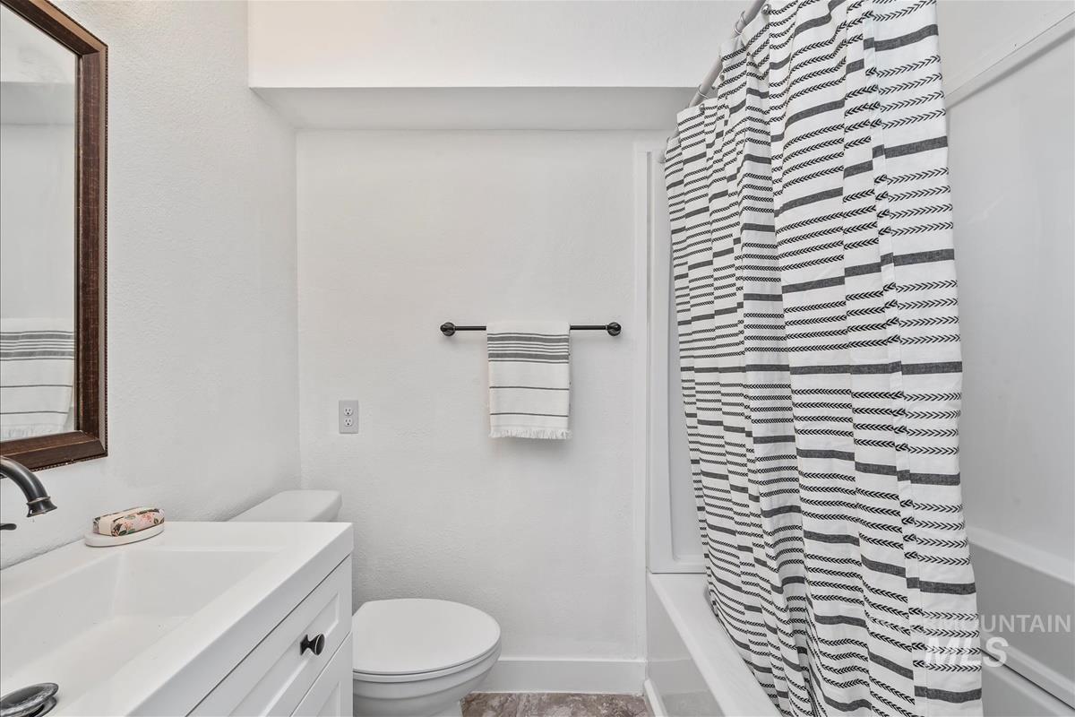 Bathroom with vanity and shower / tub combo