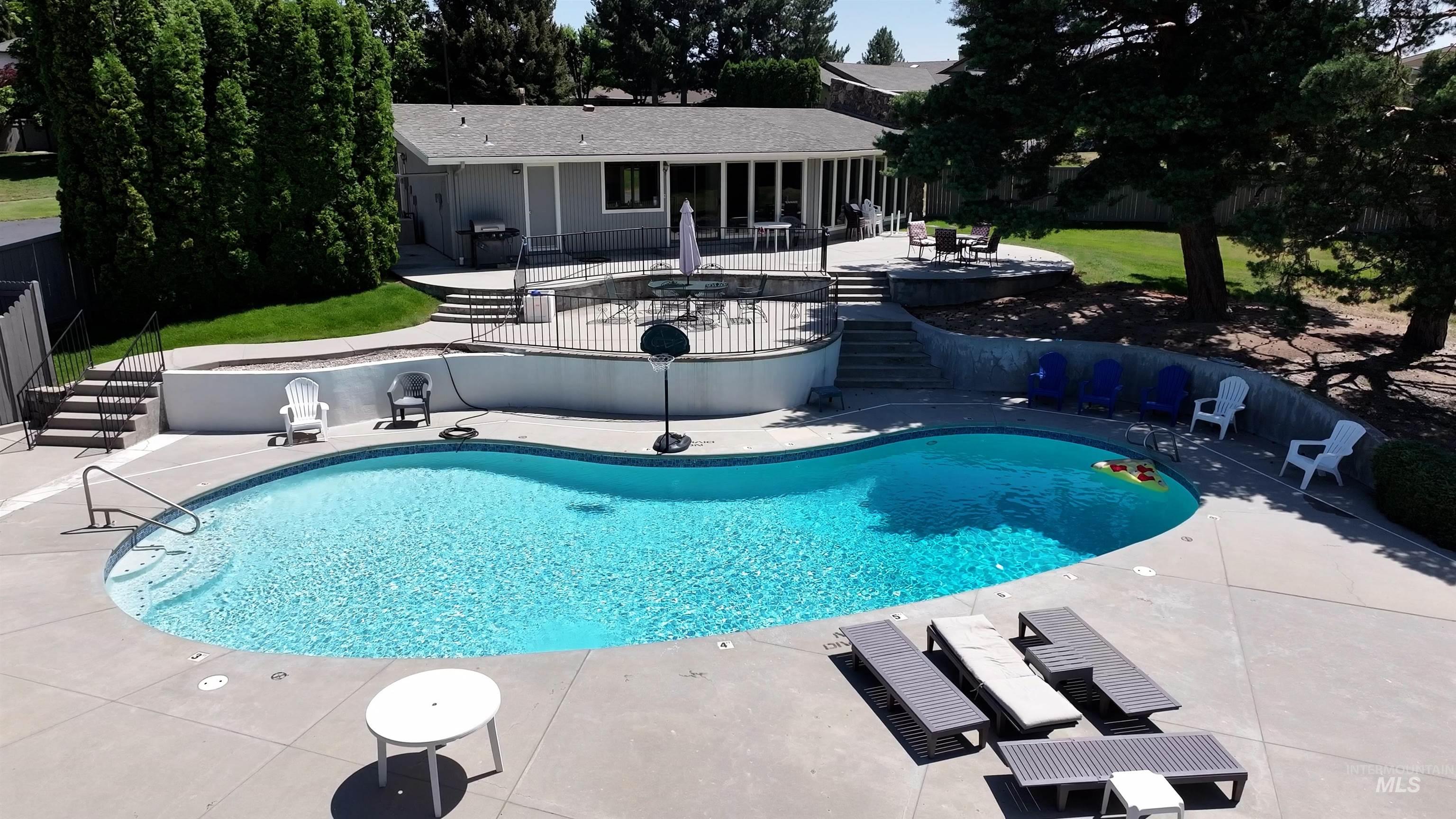 Swimming pool with a patio area and stairway