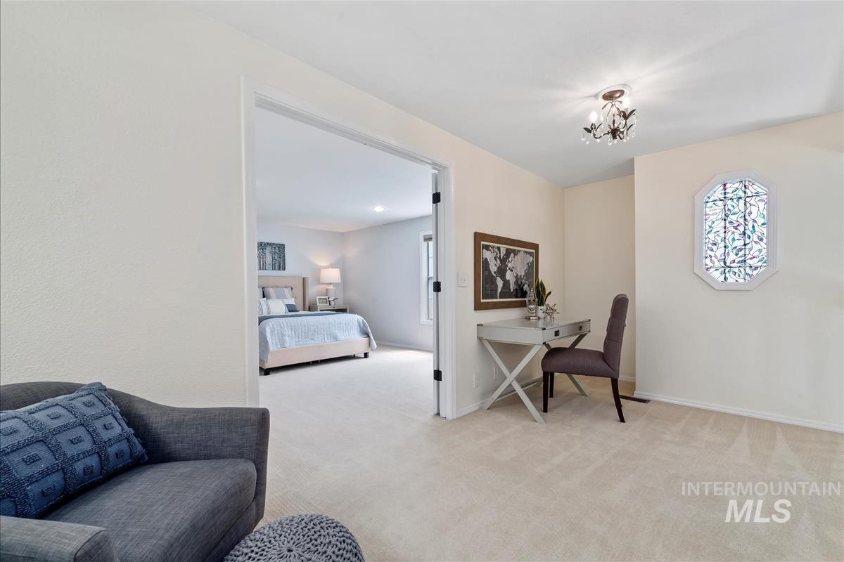 Office with light colored carpet and baseboards