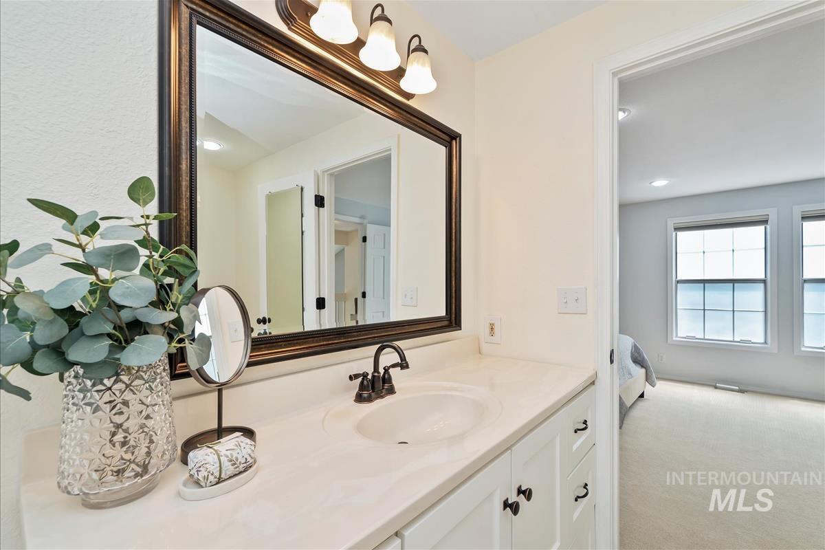 Bathroom featuring vanity, ensuite bathroom, and recessed lighting