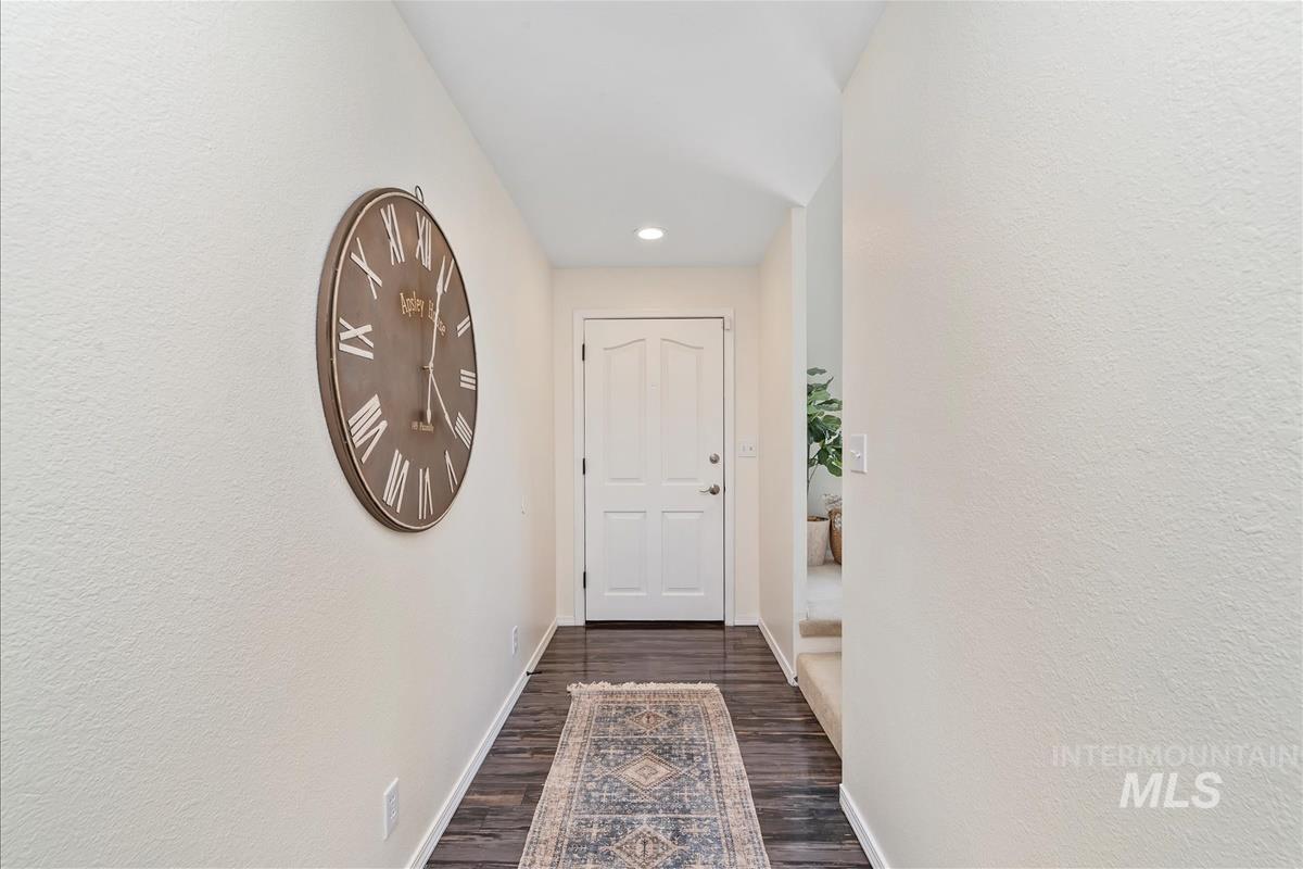 Entryway with dark wood-style flooring and recessed lighting