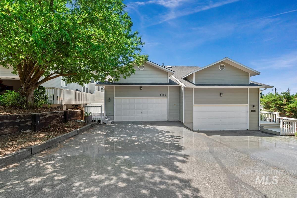 View of front of home with driveway and a garage