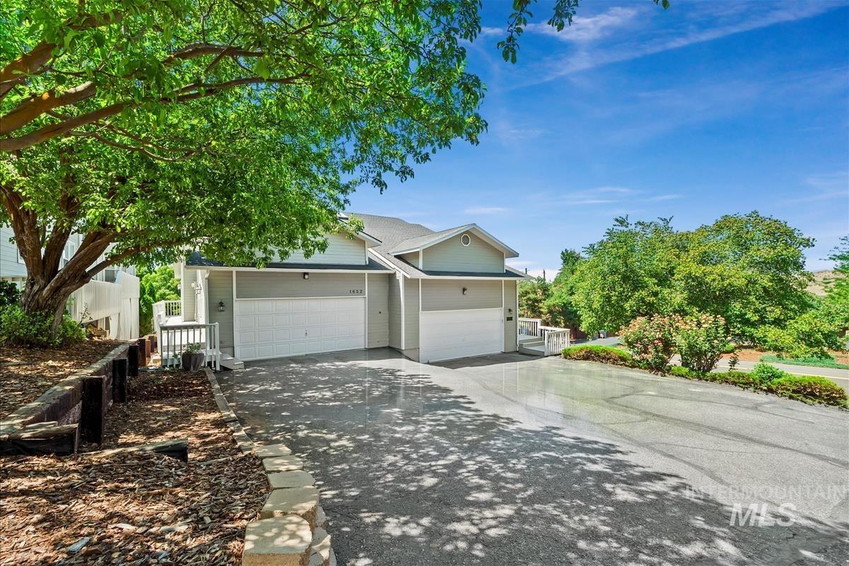 View of front facade with concrete driveway and a garage