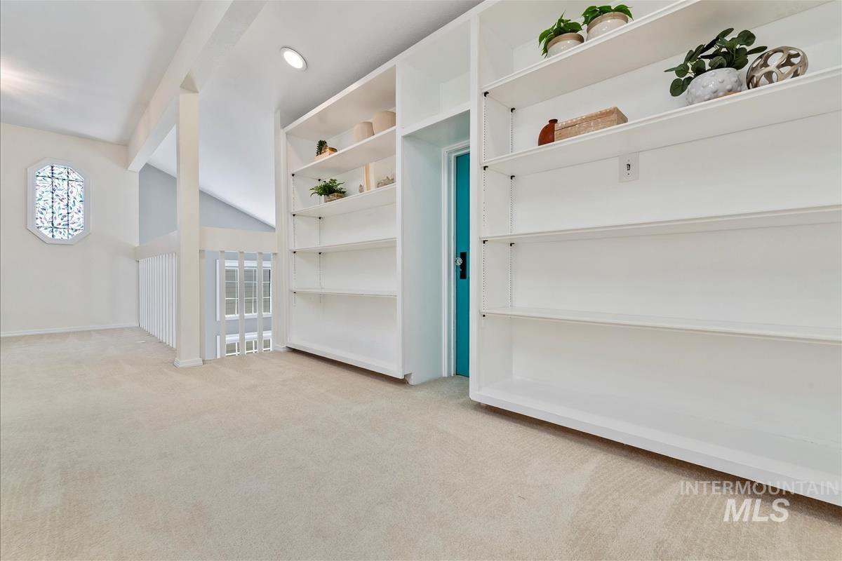 Carpeted spare room with baseboards