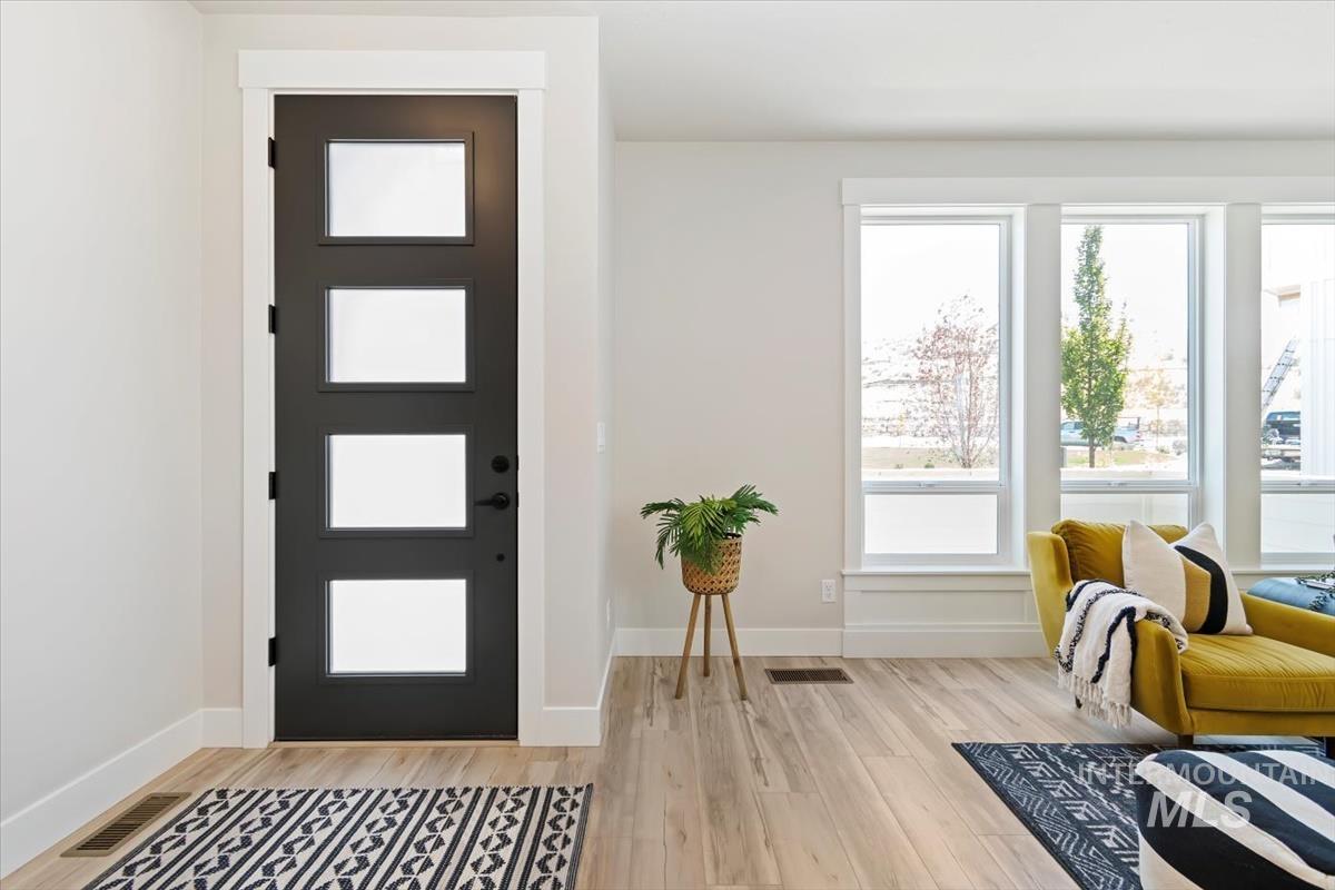 Entryway with light wood-type flooring and baseboards