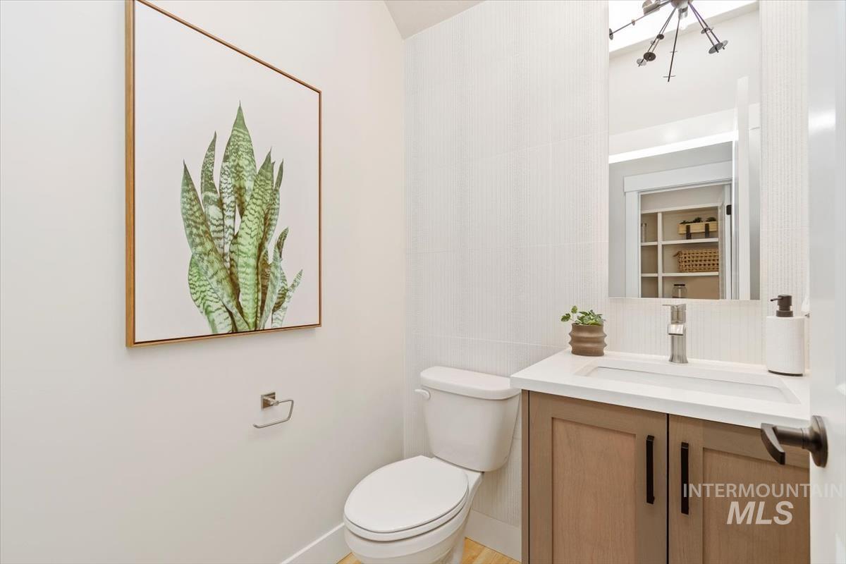 Half bath featuring vanity and toilet