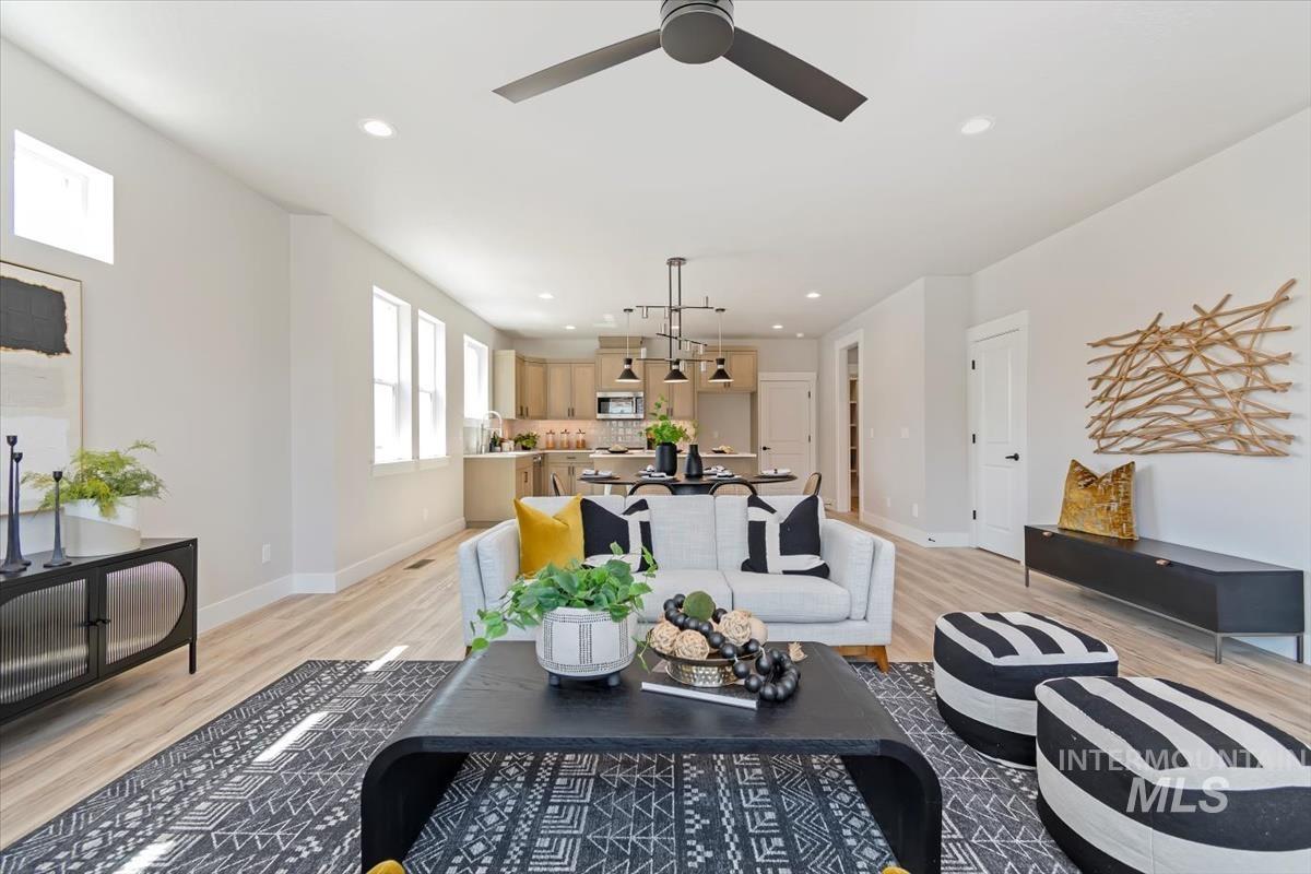 Living room with recessed lighting and light wood-style floors