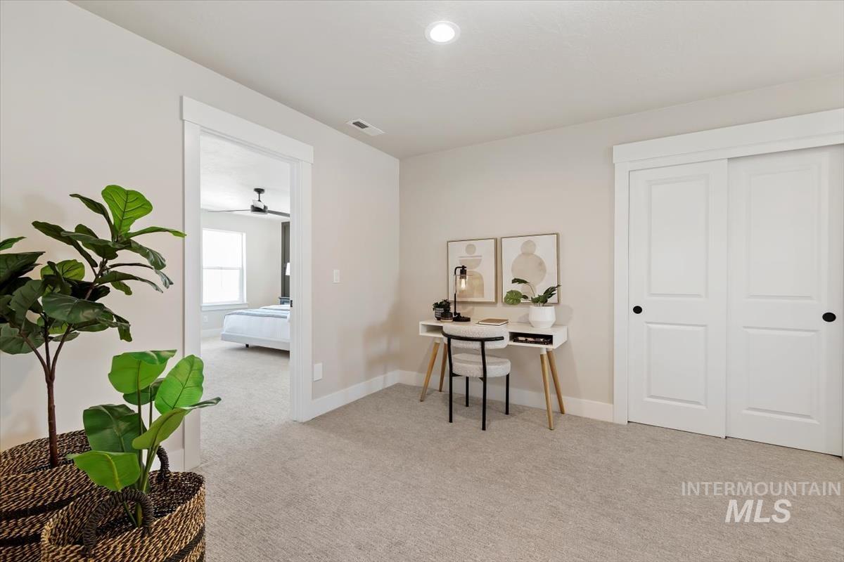Office space featuring light colored carpet and recessed lighting
