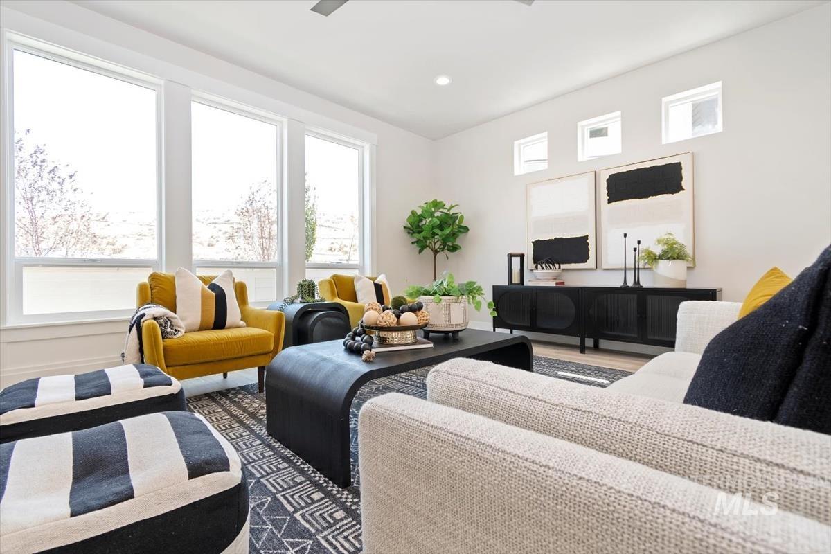 Living room featuring recessed lighting, dark wood finished floors, and a ceiling fan