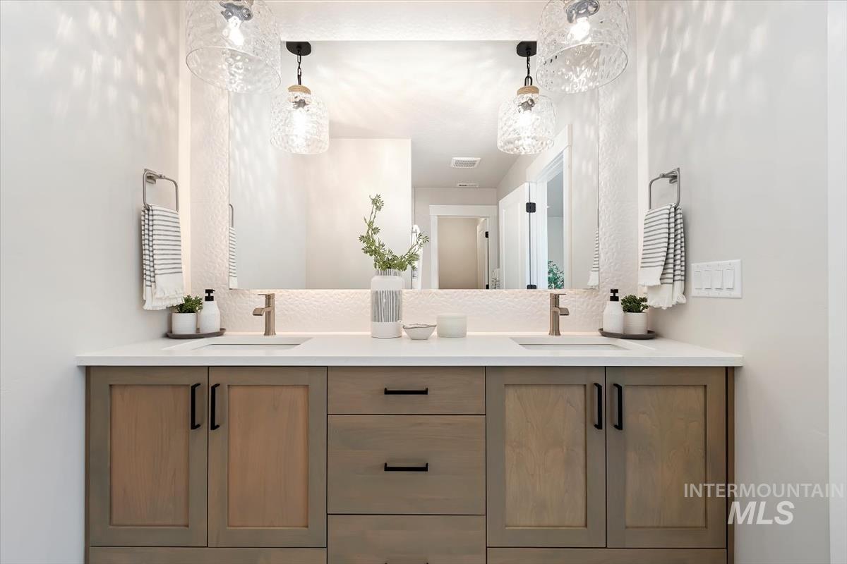 Full bath featuring double vanity