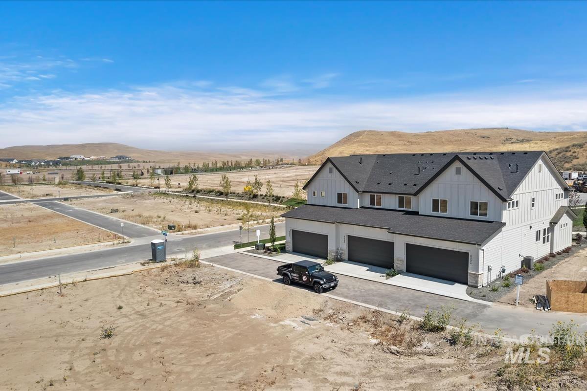 Aerial view of property and surrounding area with mountains
