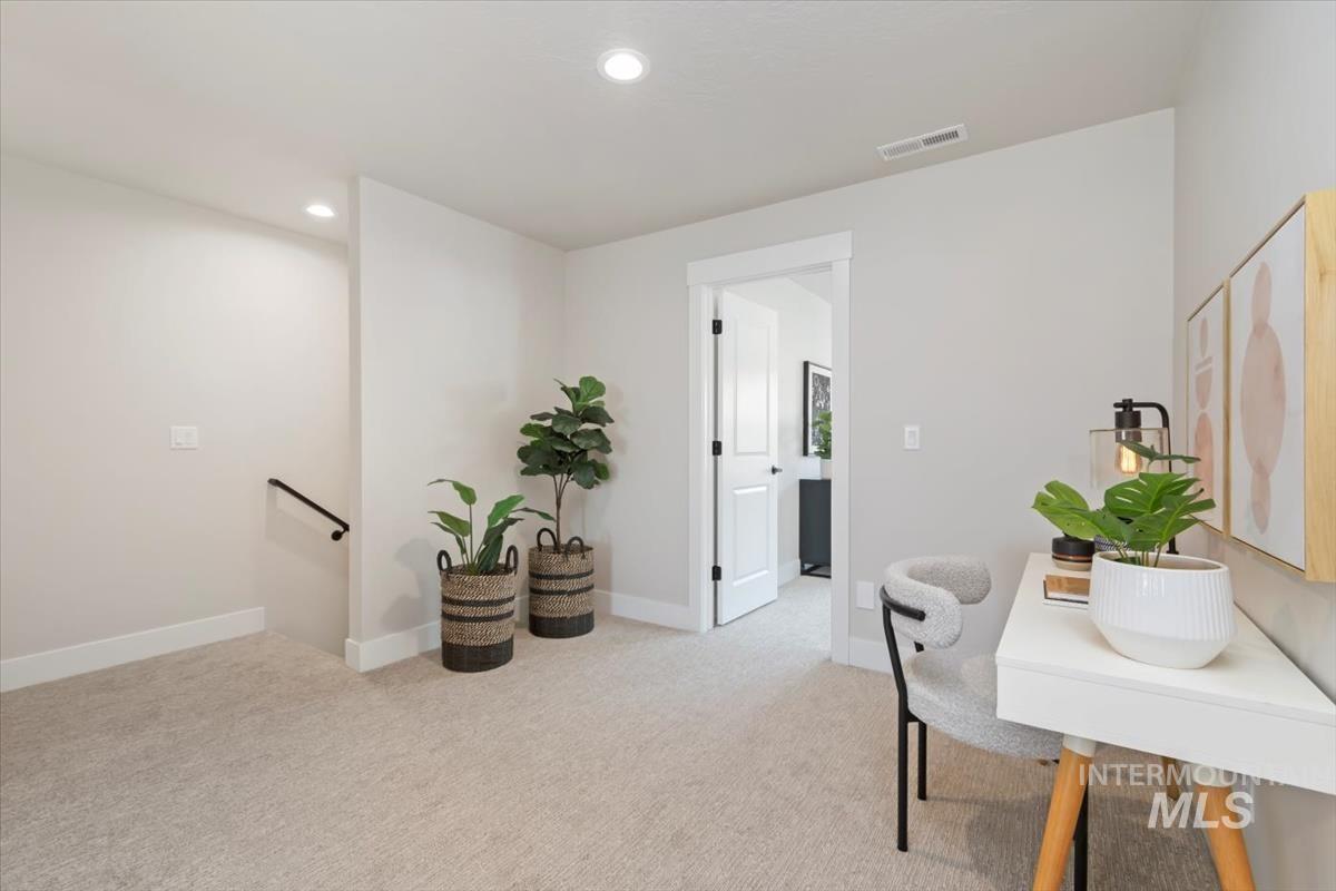 Office area with recessed lighting and light colored carpet