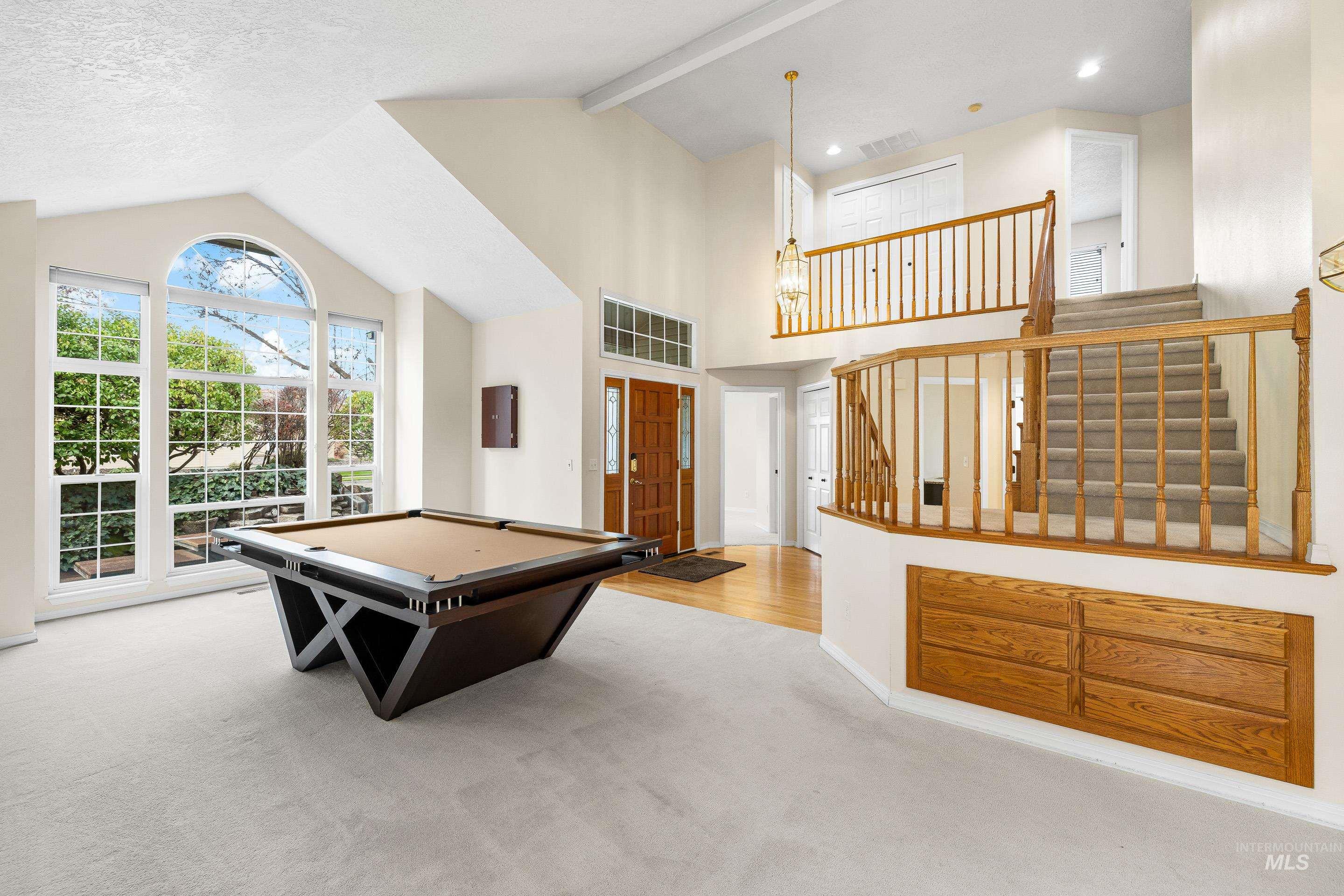 Playroom featuring pool table, beam ceiling, light carpet, and high vaulted ceiling