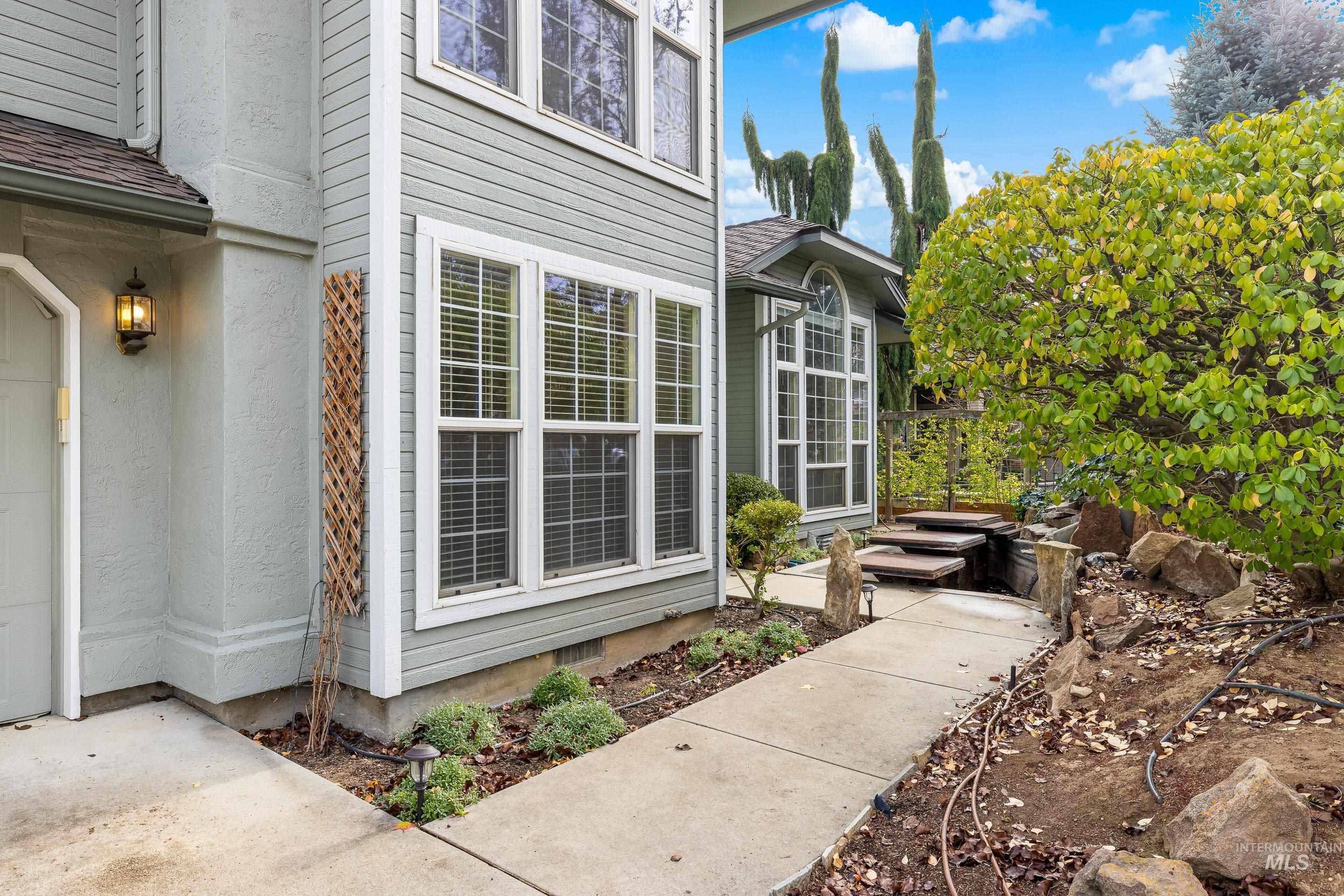 View of exterior entry featuring a shingled roof