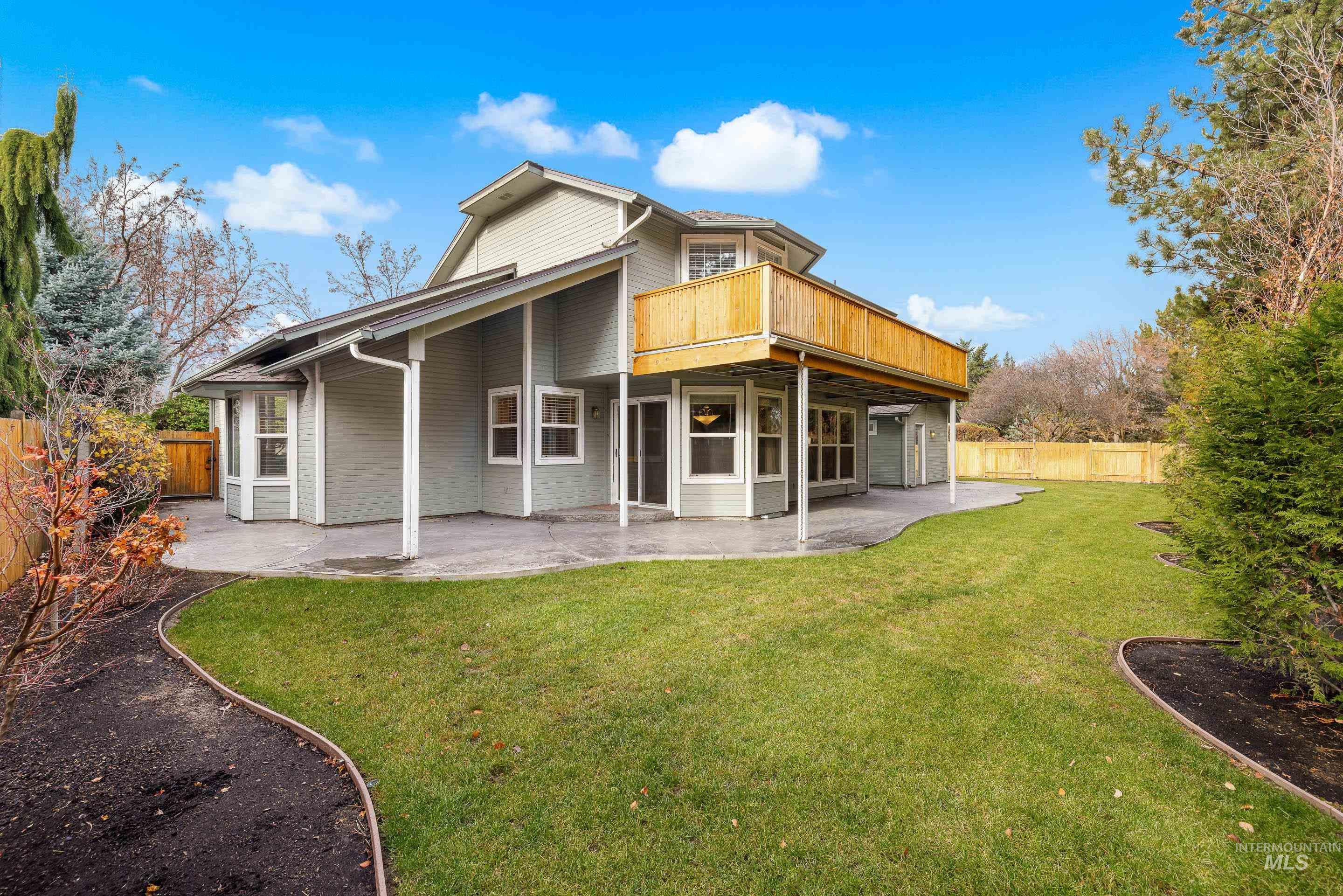 Back of house featuring a patio area, a fenced backyard, and a deck