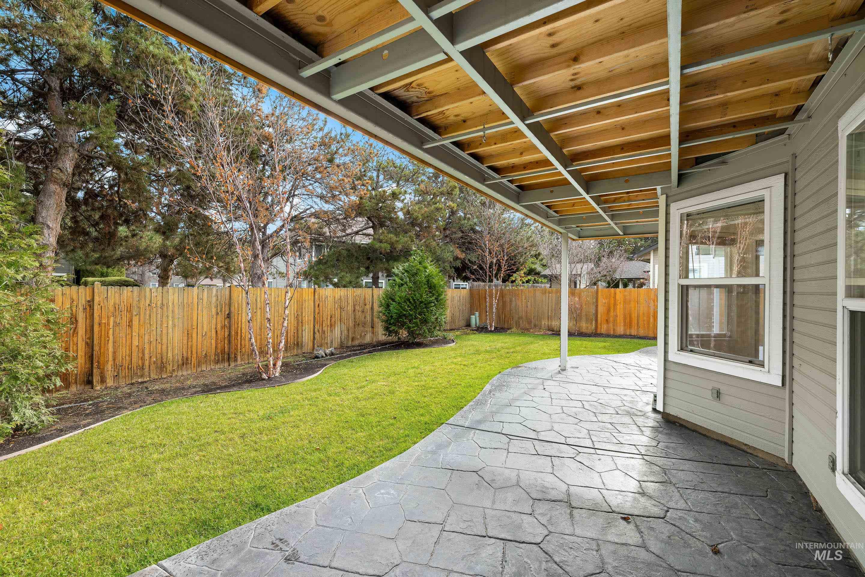 Fenced backyard with a patio area
