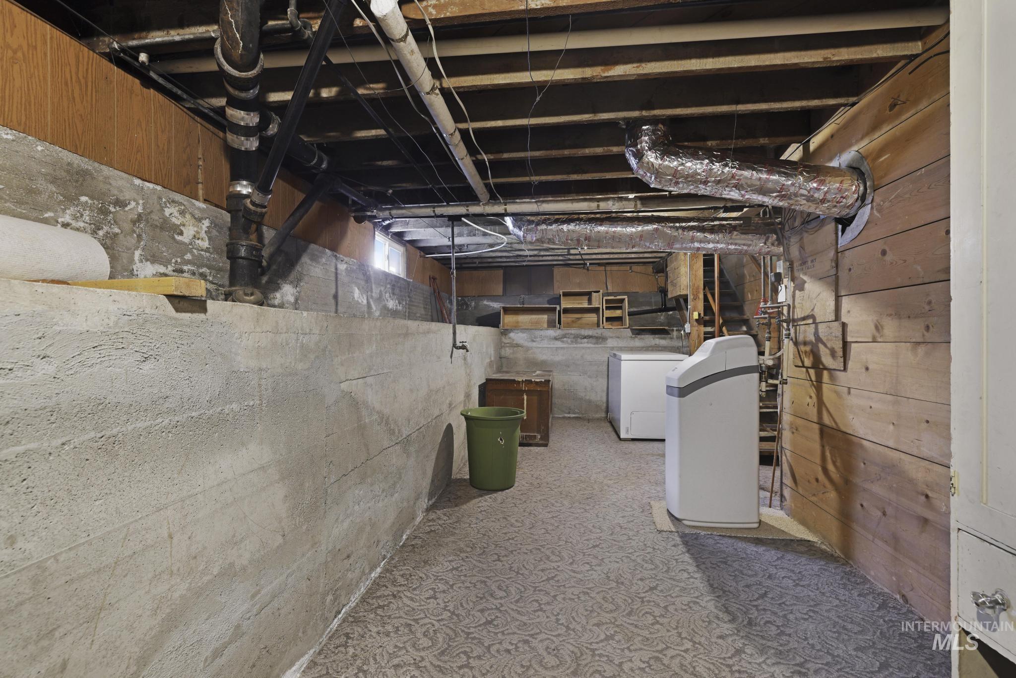 Unfinished basement with a water softener system