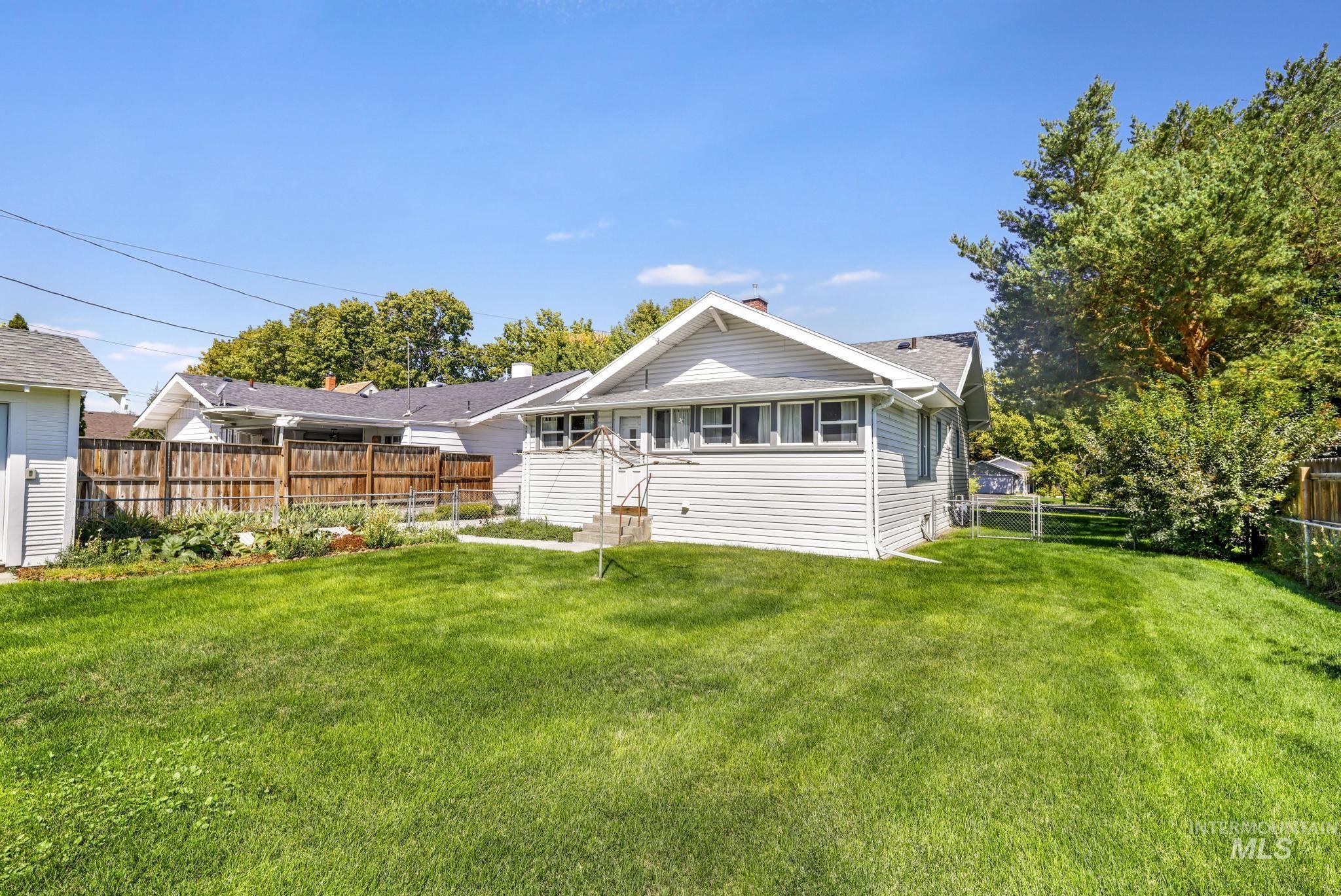 Rear view of house with a fenced backyard