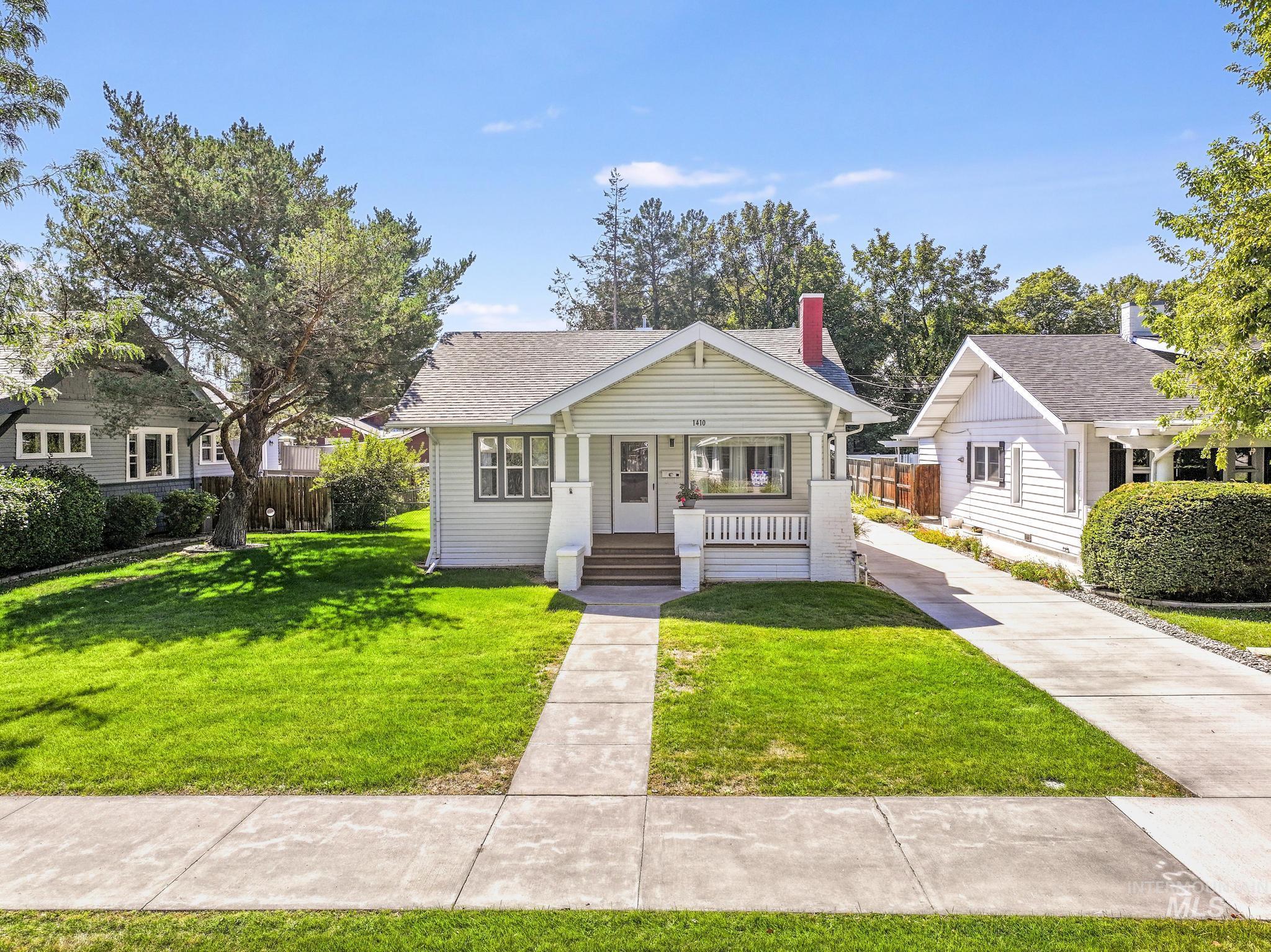 Bungalow-style house with a porch and roof with shingles