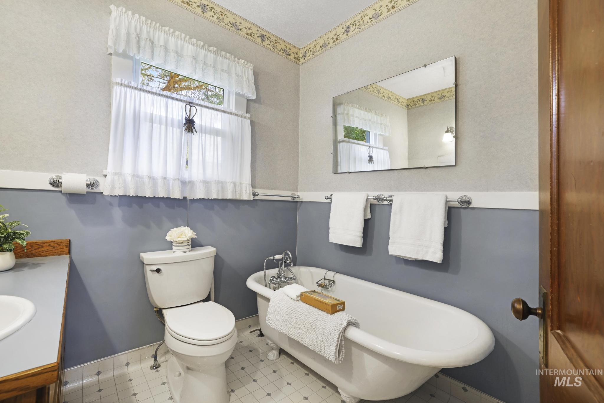 Bathroom with a freestanding tub and vanity