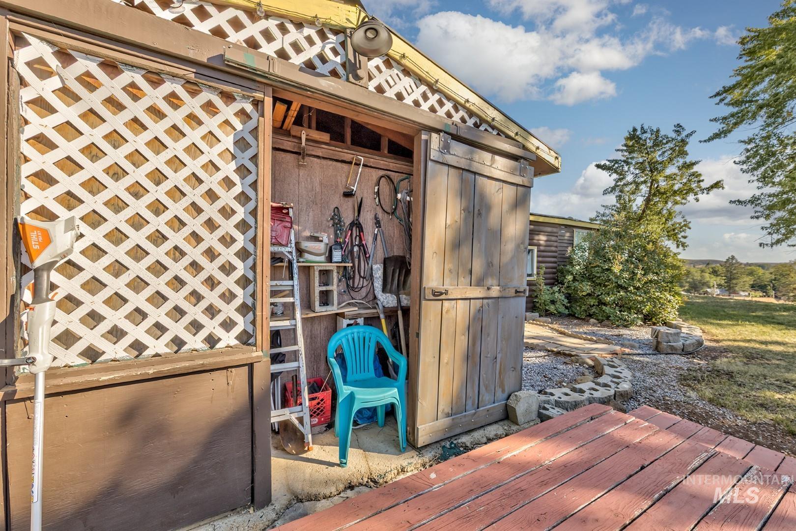 Wooden deck featuring an outdoor structure