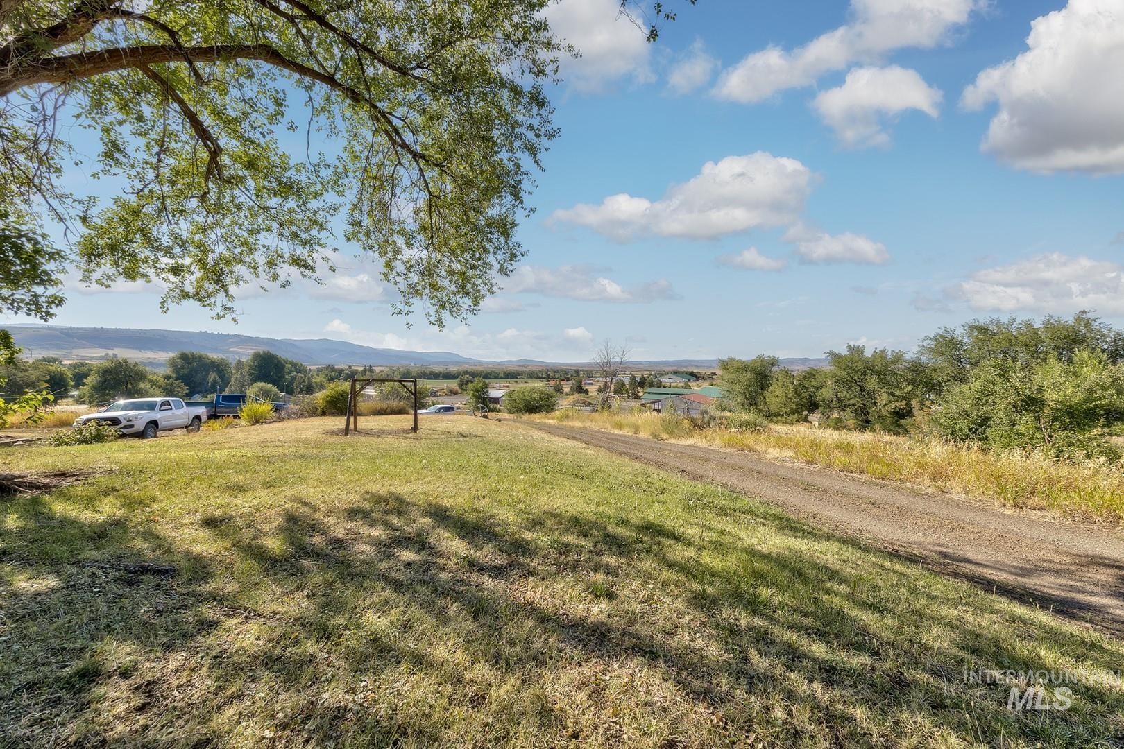 View of green lawn featuring a view of countryside and a mountain view